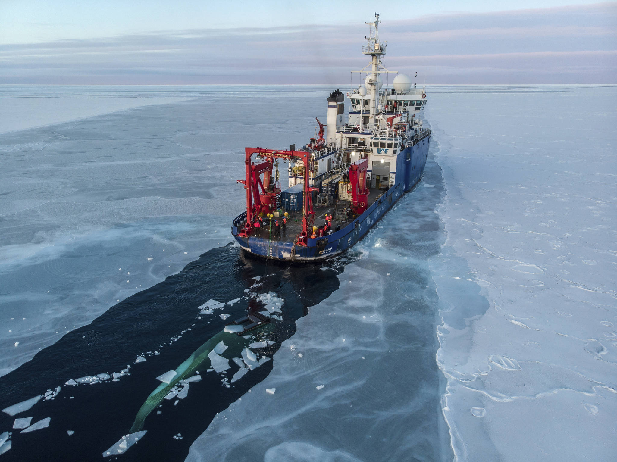 In this Nov. 14, 2019, photo provided by John Guillote and taken from an aerial drone shows the U.S. research vessel Sikuliaq as it makes its way through sea ice in the Beaufort Sea off Alaska’s north coast. University of Washington scientists onboard the research vessel are studying the changes and how less sea ice will affect coastlines, which already are vulnerable to erosion because increased waves delivered by storms. More erosion would increase the chance of winter flooding in villages and danger to hunters in small boats. (John Guillote via AP)