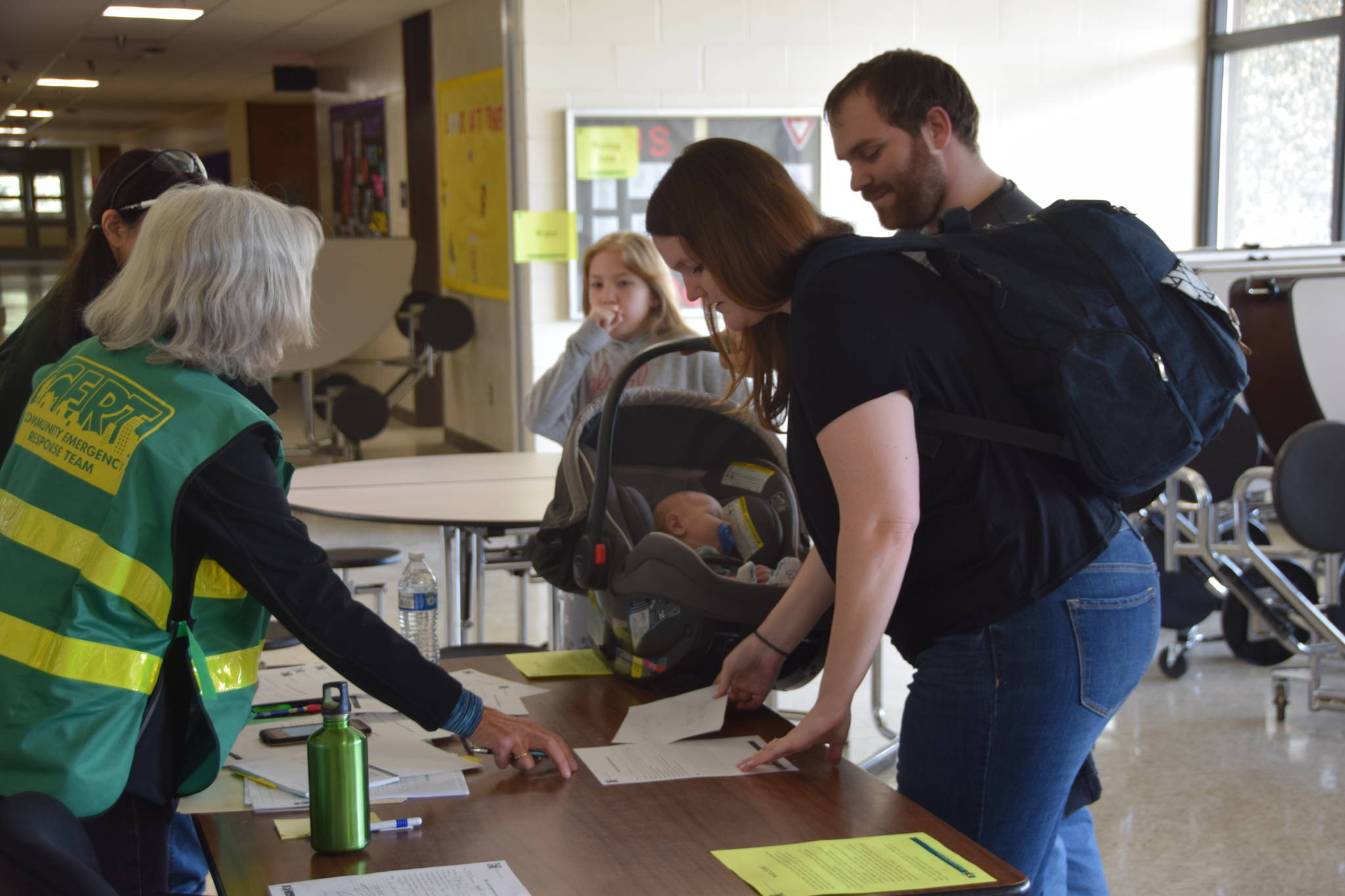 CERT volunteers sign people in to the Disaster Help Center at Kenai Middle School in Kenai, Alaska, during OEM’s Alaska Shield 2019 program on April 13, 2019. (Photo by Brian Mazurek/Peninsula Clarion)