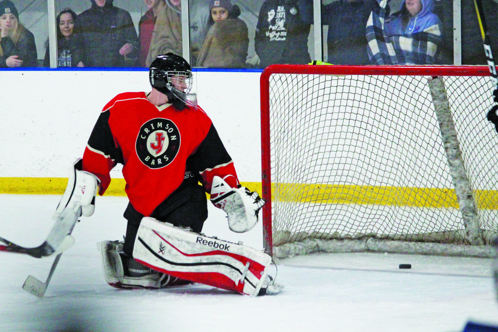 Juneau-Douglas goaltender Cody Mitchell turns to see the puck sliding into the net during a Friday, Dec. 6, 2019 hockey game against Homer High School at the Kevin Bell Arena in Homer, Alaska. (Megan Pacer | Homer News)