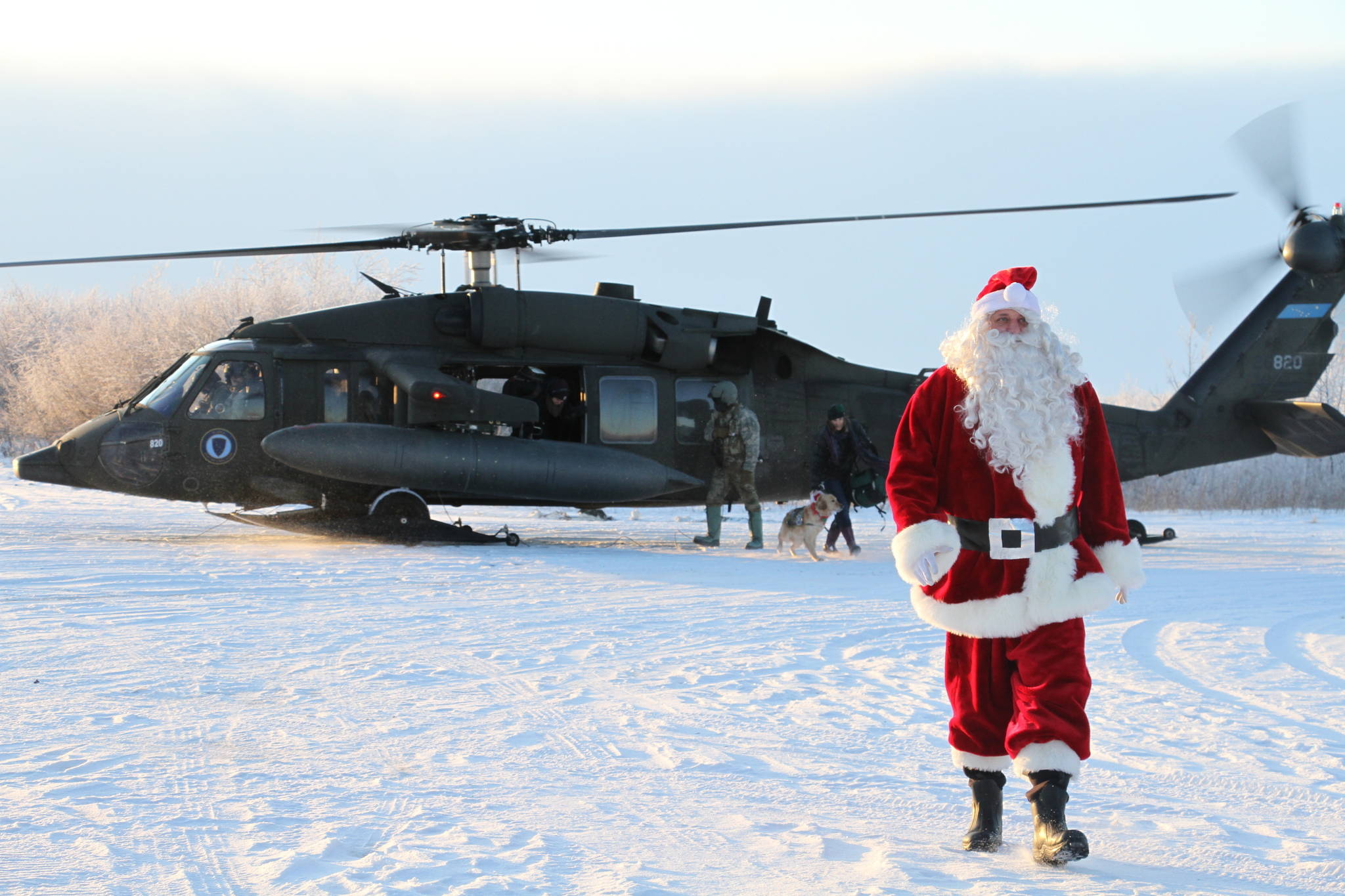 This Dec. 3, 2019 photo shows Santa Claus arriving in Napakiak, Alaska, on an Alaska National Guard UH-60 Black Hawk helicopter. The Guard brought its Operation Santa Claus to the western Alaska community, which is being severely eroded by the nearby Kuskokwim River. (AP Photo/Mark Thiessen)