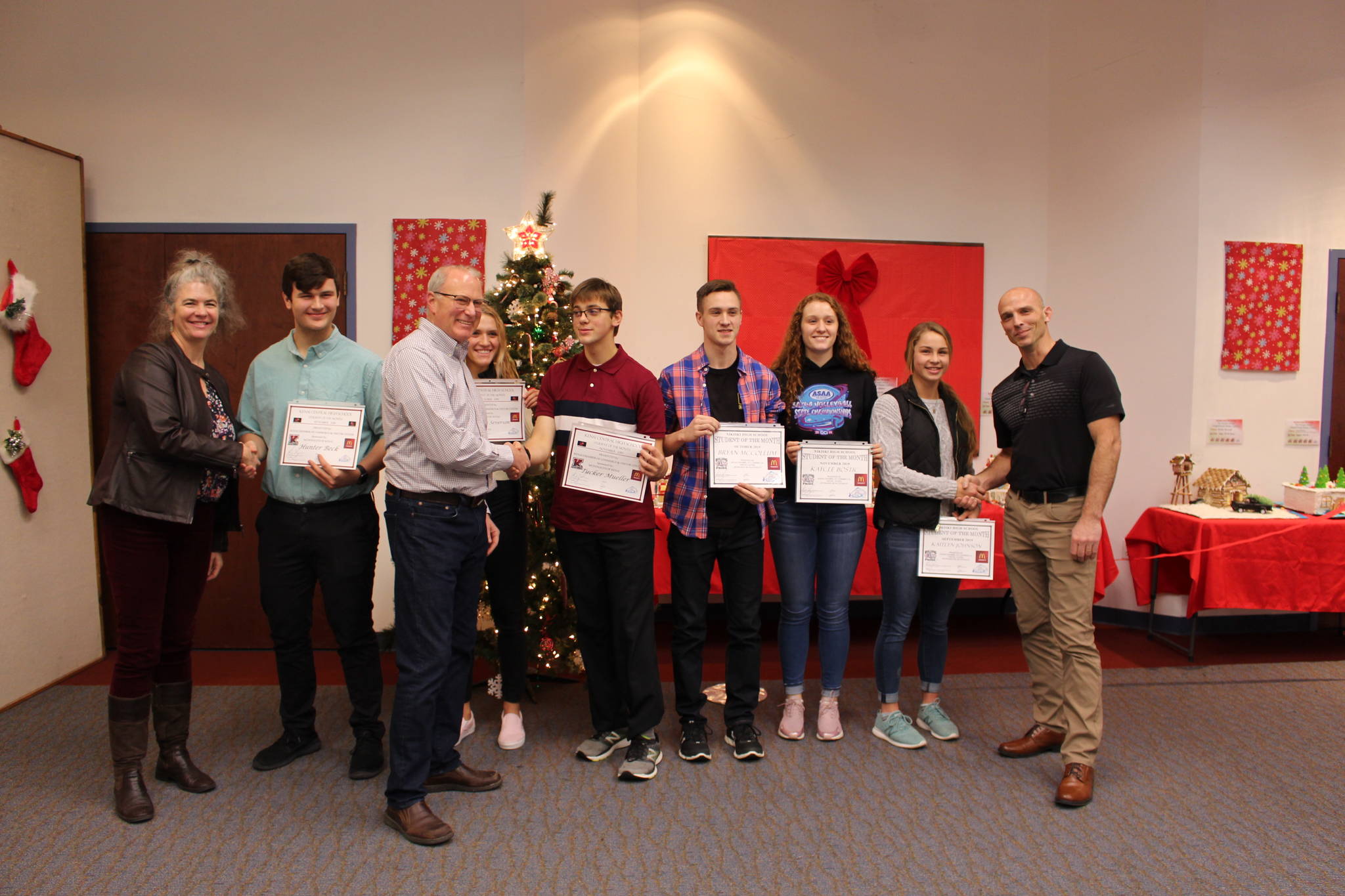 Students from Kenai Central and Nikiski Middle/High School are recognized as Students of the Month at the Kenai and Soldotna Chambers of Commerce Luncheon at the Kenai Visitor and Cultural Center on Dec. 4, 2019. From left: Kenai Central High School Principal Briana Randle, Hunter Beck, Scott Cunningham, Damaris Severson, Tucker Mueller, Bryan McCollum, Kaycee Bostic, Kaitlyn Johnson and Nikiski Middle/High School Principal Dan Carstens. (Photo by Brian Mazurek/Peninsula Clarion)