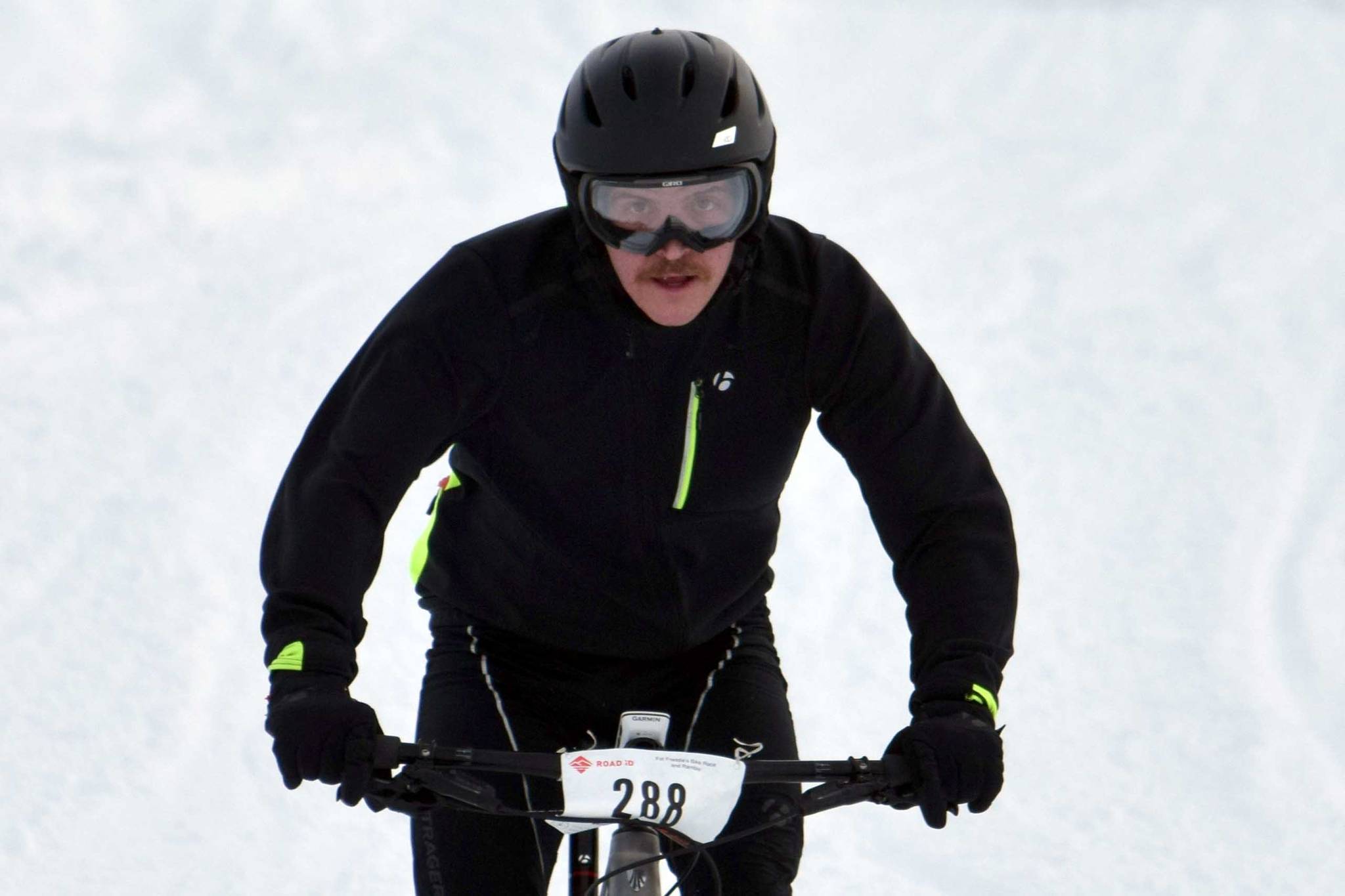 Mike Crawford barrels down a hill during Fat Freddie’s Bike Race and Ramble on Saturday, Feb. 9, 2019, in the Caribou Hills near Freddie’s Roadhouse. (Photo by Jeff Helminiak/Peninsula Clarion)