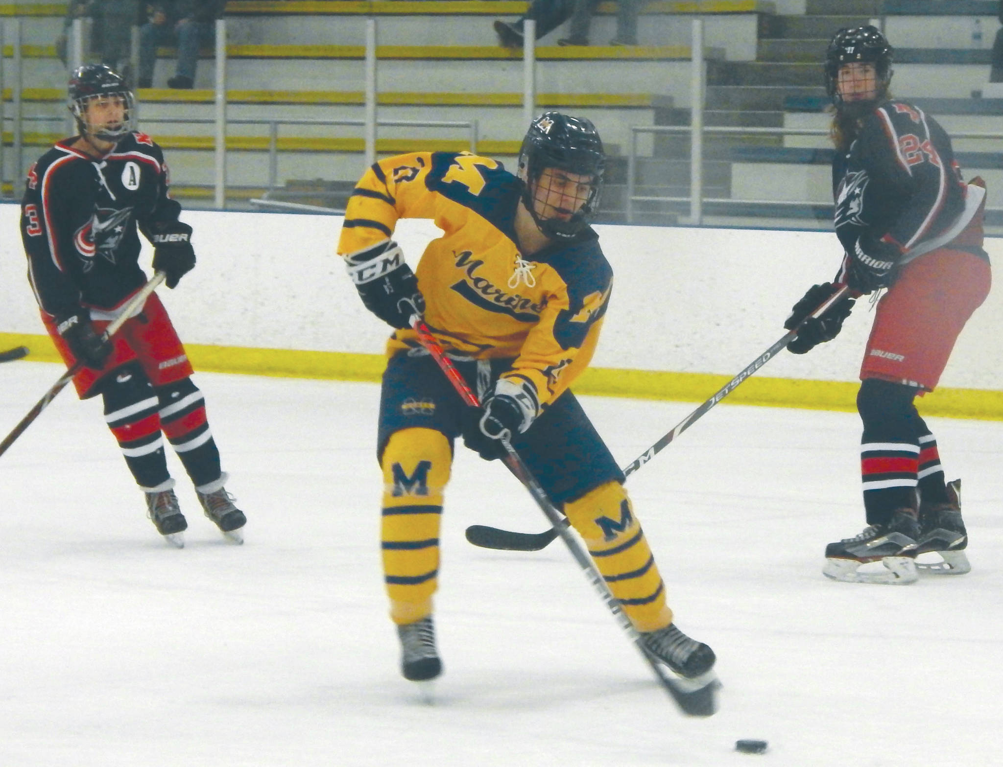 kHomerճ Isaiah Nevak drives away from North Poleճ Blake Battcher (3) and Ethan Frollo (24) on Friday night during the second period of a semifinal of the ASAA/First National Cup Division II State Championships at the University of Alaska Fairbanks Patty Ice Arena. (Photo by Danny Martin/Fairbanks Daily News-Miner)