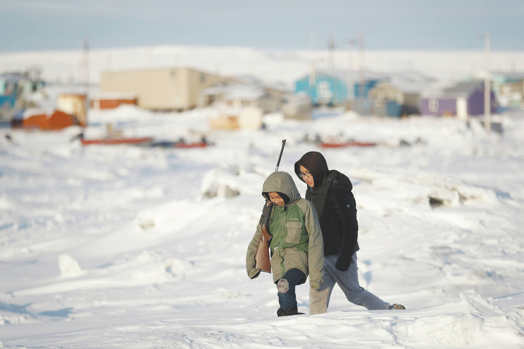 Gregory Bull / Associated Press file                                George Chakuchin (left) and Mick Chakuchin walk on ice over the Bering Sea in Toksook Bay, on Jan. 18. Motor vehicle offices across the U.S. have experienced high demand as an Oct. 1 deadline approaches for Real IDs, special licenses many will need to board domestic flights and enter military bases and some federal buildings, but in remote parts of the country, like rural Alaska, those ID cards may be harder to get. People in Toksook Bay rely on small planes to travel off the island. The near DMV office is 115 miles away in Bethel.