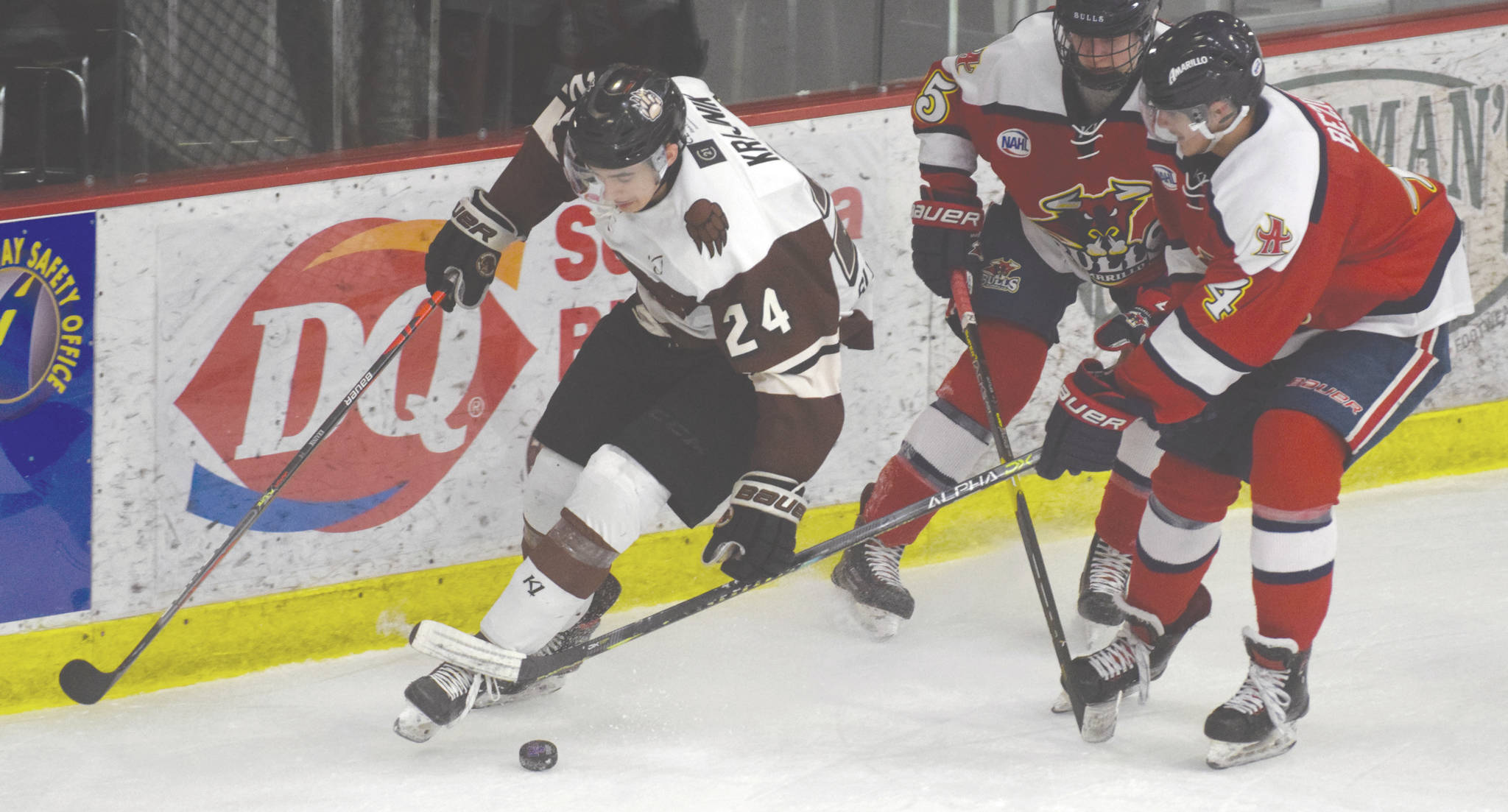 Kenai River forward Zach Krajnik carries the puck in front of Nick Dineen and Oliver Bezick of the Amarillo (Texas) Bulls on Friday at the Soldotna Regional Sports Complex in Soldotnaº. (Photo by Jeff Helminiak/Peninsula Clarion)