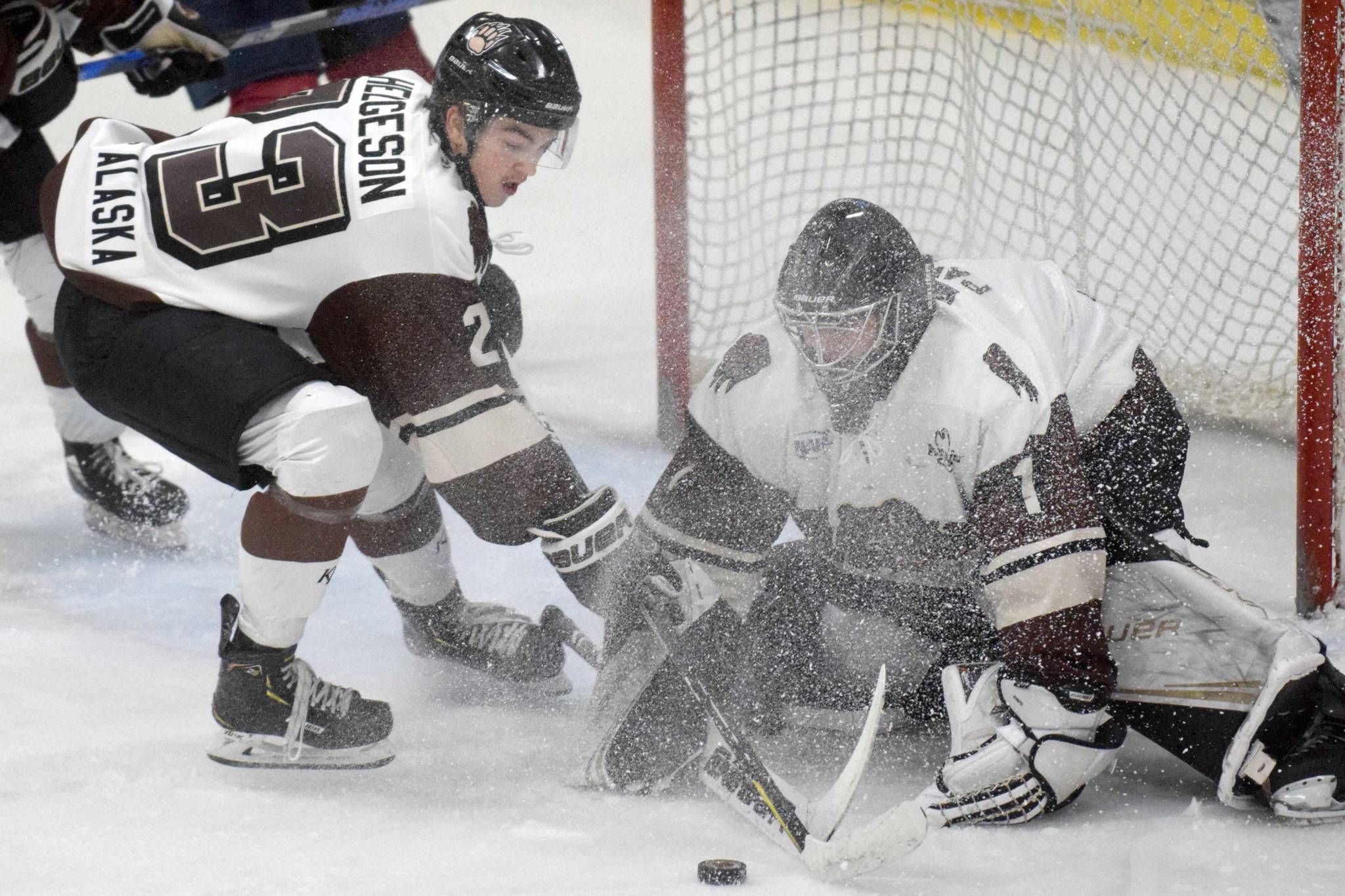 Kenai River Brown Bears forward Max Helgeson and goalie Landon Pavlisin keep the Fairbanks Ice Dogs from scoring Friday, Nov. 22, 2019, at the Soldotna Regional Sports Complex in Soldotna, Alaska. (Photo by Jeff Helminiak/Peninsula Clarion)