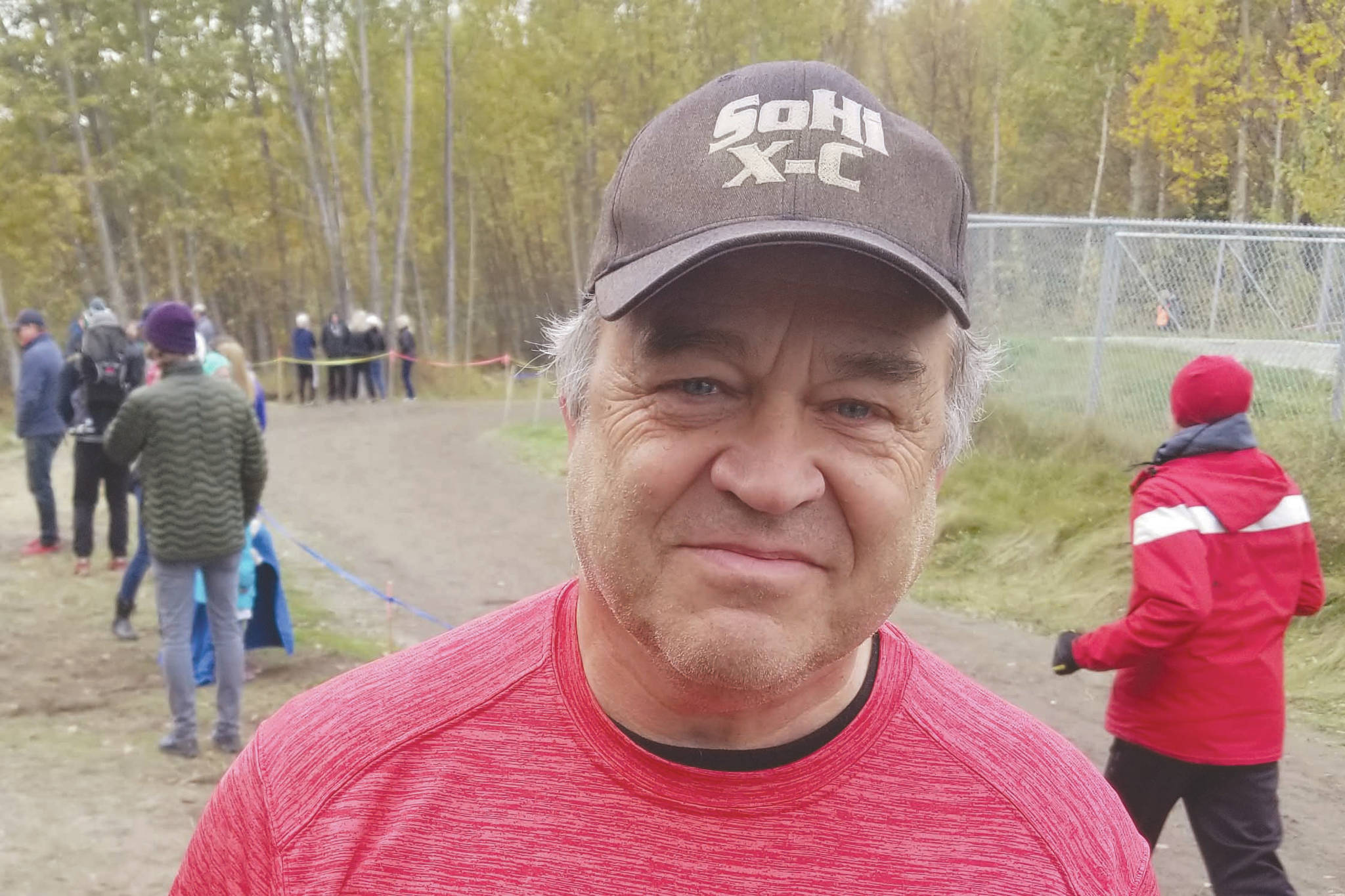 During the 2019 cross-country season, Soldotna High School coach Ted McKenney put on Kenai Central gear to support the Kardinals in the small-schools race before switching back to SoHi gear for the big-schools race. (Photo by Crystal McKenney)