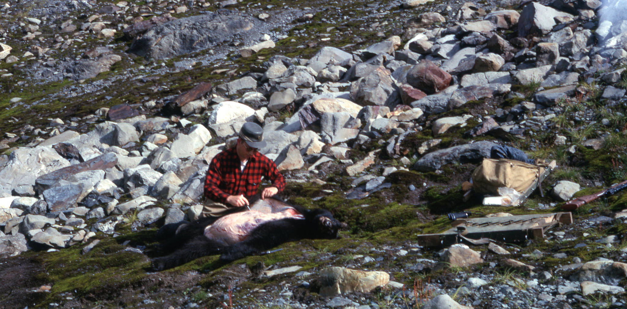 Calvin Fair skins out a black bear he shot in the Tustumena Glacier area in 1963.