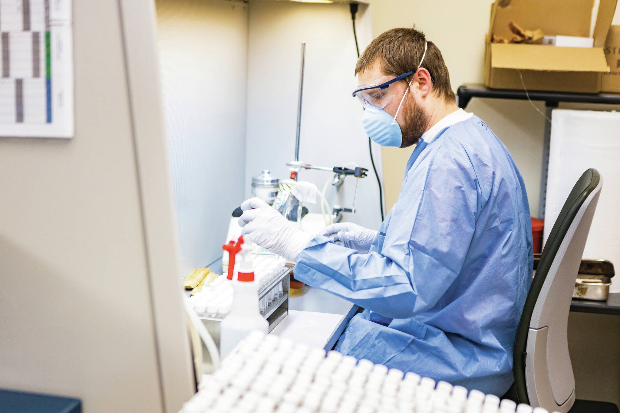 University of Alaska Fairbanks student Ben Hedges adds viral transport medium to vials at the Alaska State Virology Laboratory located at the Fairbanks campus Wednesday, April 8, 2020. The virology lab manufactures VTMs onsite for COVID-19 test kits for the state of Alaska. Hedges is a biological sciences major. (UAF Photo by JR Ancheta).