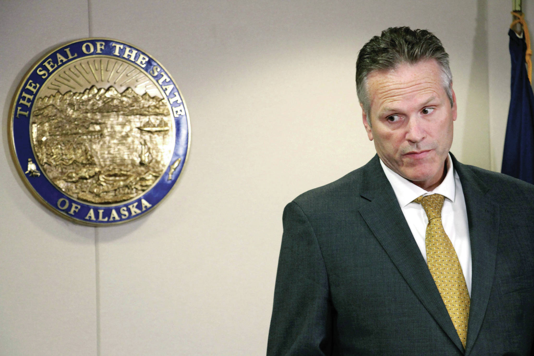 Mark Thiessen / Associated Press file                                Alaska Gov. Mike Dunleavy listens during a news conference in Anchorage on Sept. 26.