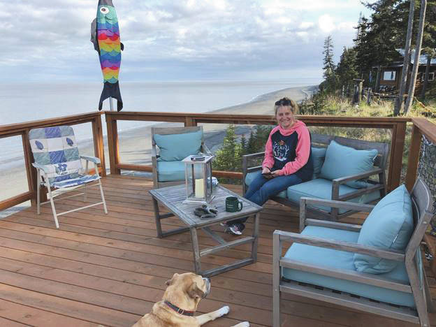 Tammy Kehrer of Palmer sits on the deck overlooking Cook Inlet at Ocean Bluff B&B in Kasilof. Kehrer is the daughter of owner Kathy Carlisle. (Photo provided by Ocean Bluff B&B)