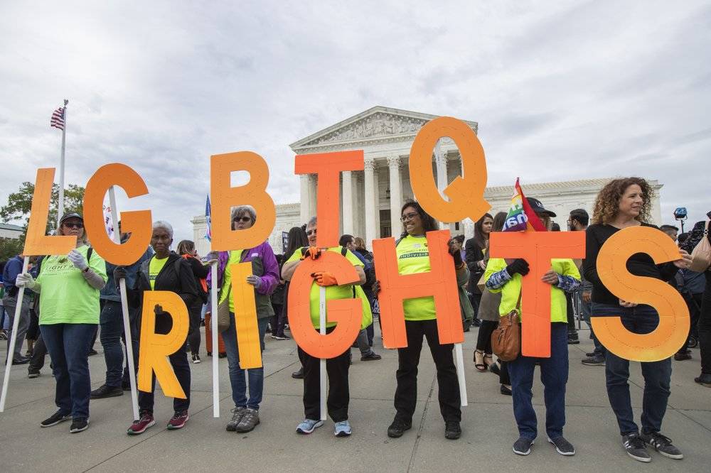 Manuel Balce Ceneta | associated press file                                Supporters of LGBTQ+ rights hold placards in front of the U.S. Supreme Court in Washington on Oct. 8, 2019. The Supreme Court ruled Monday that a landmark civil rights law protects gay, lesbian and transgender people from discrimination in employment. It’s a resounding victory for LGBTQ+ rights from a conservative court.