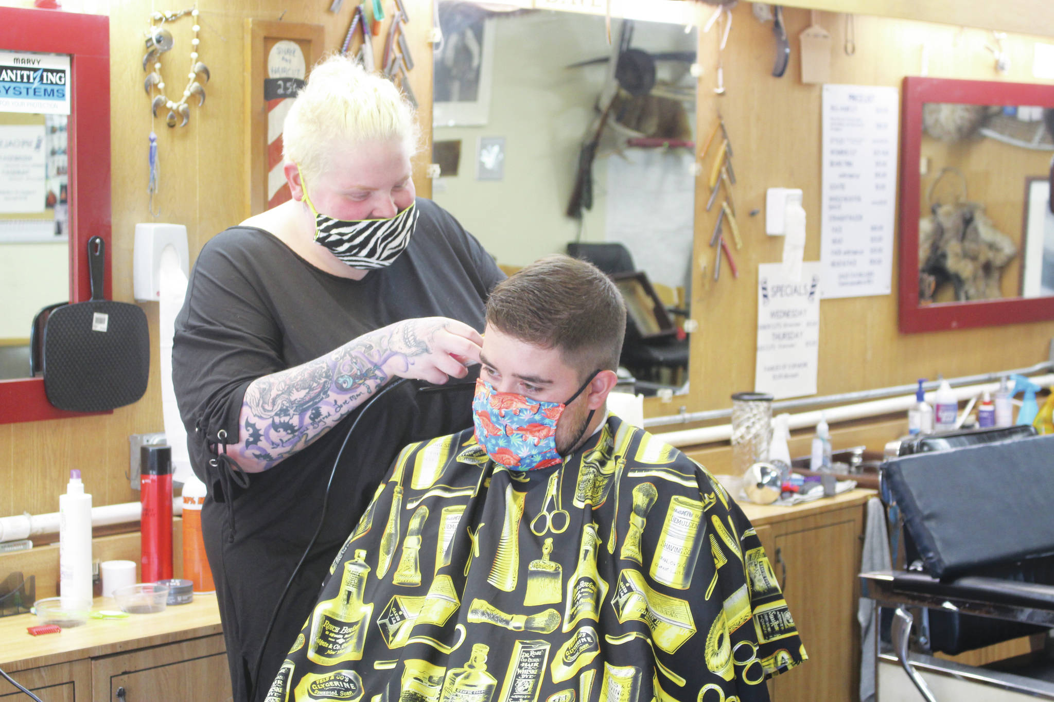 Photo by Brian Mazurek/Peninsula Clarion                                Skylar Giordano cuts Ryan Huerta’s hair at RD’s Barber Shop in Kena on Thursday. RD’s is one of the 186 local businesses and nonprofits in Kenai that already received financial assistance through the City of Kenai’s Grant Program.