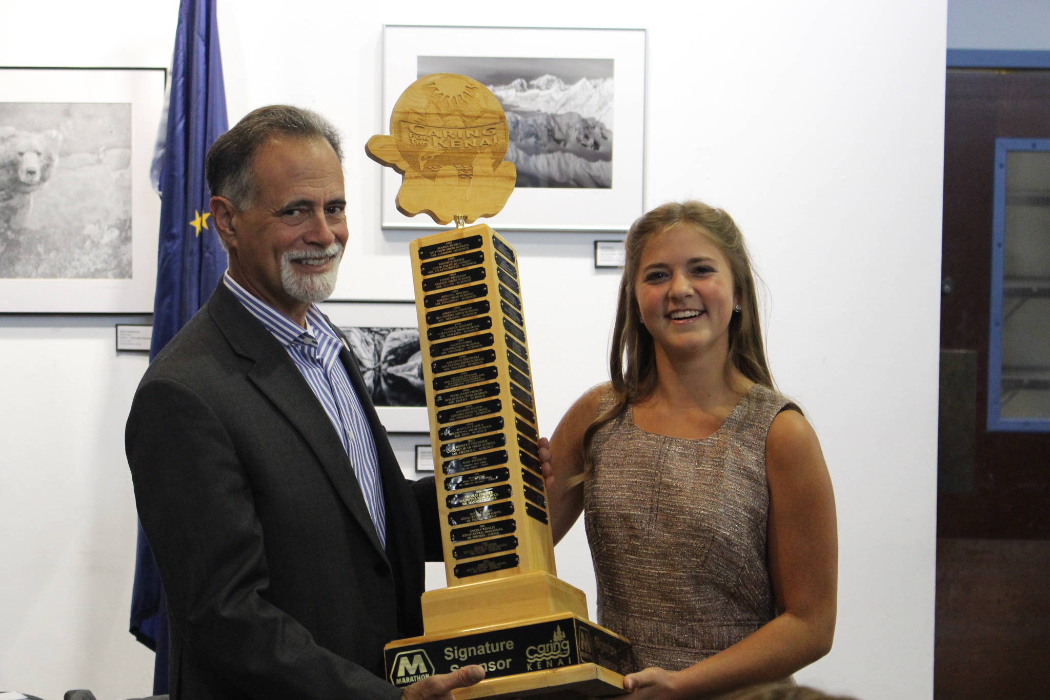 Sen. Peter Micciche, R - Soldotna, hands off the 1st place Caring for the Kenai trophy to Anna DeVolld at the Kenai Visitor Center on Aug. 19, 2020. (Photo by Brian Mazurek/Peninsula Clarion)