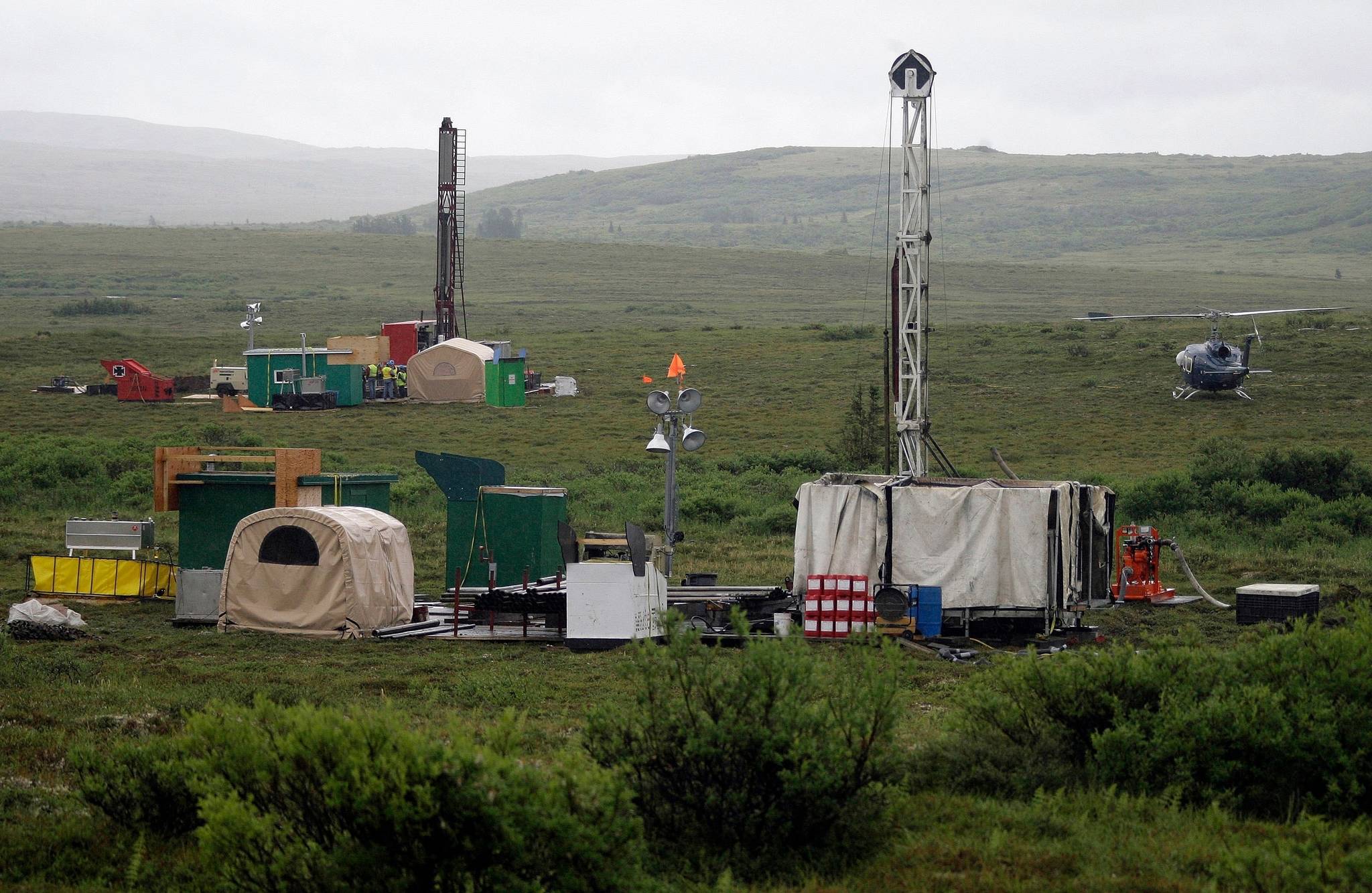 In this July 13, 2007, file photo, workers with the Pebble Mine project test drill in the Bristol Bay region of Alaska, near the village of Iliamma. A proposed gold and copper mine at the headwaters of the world’s largest sockeye salmon fishery in Alaska would cause “unavoidable adverse impacts,” the U.S. Army Corps of Engineers said in a letter to the developer released Monday, Aug. 24, 2020. The corps is asking the backers of Pebble Mine to come up with a mitigation plan within 90 days for nearly 3,000 acres of land and nearly 200 miles of streams it says could be affected if the controversial mine moves forward. (AP Photo/Al Grillo, File)