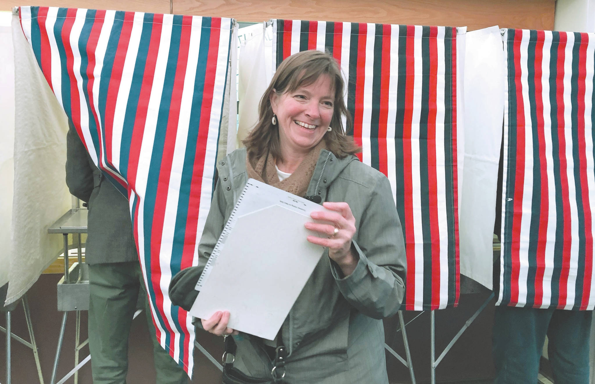 In this Nov. 6, 2018, file photo, Alaska independent U.S. House candidate Alyse Galvin smiles after emerging from a voting booth in Anchorage, Alaska. U.S. Rep. Don Young, the longest-ever serving Republican in the House, has not agreed to participate in many debates or forums this fall. “He’s dodging, he’s ducking debates because he’s afraid to talk the issues that Alaskans really care about most,” Galvin said Thursday, Oct. 1, 2020, of her 87-year-old opponent who has been in office since 1973. (AP Photo/Becky Bohrer, File)