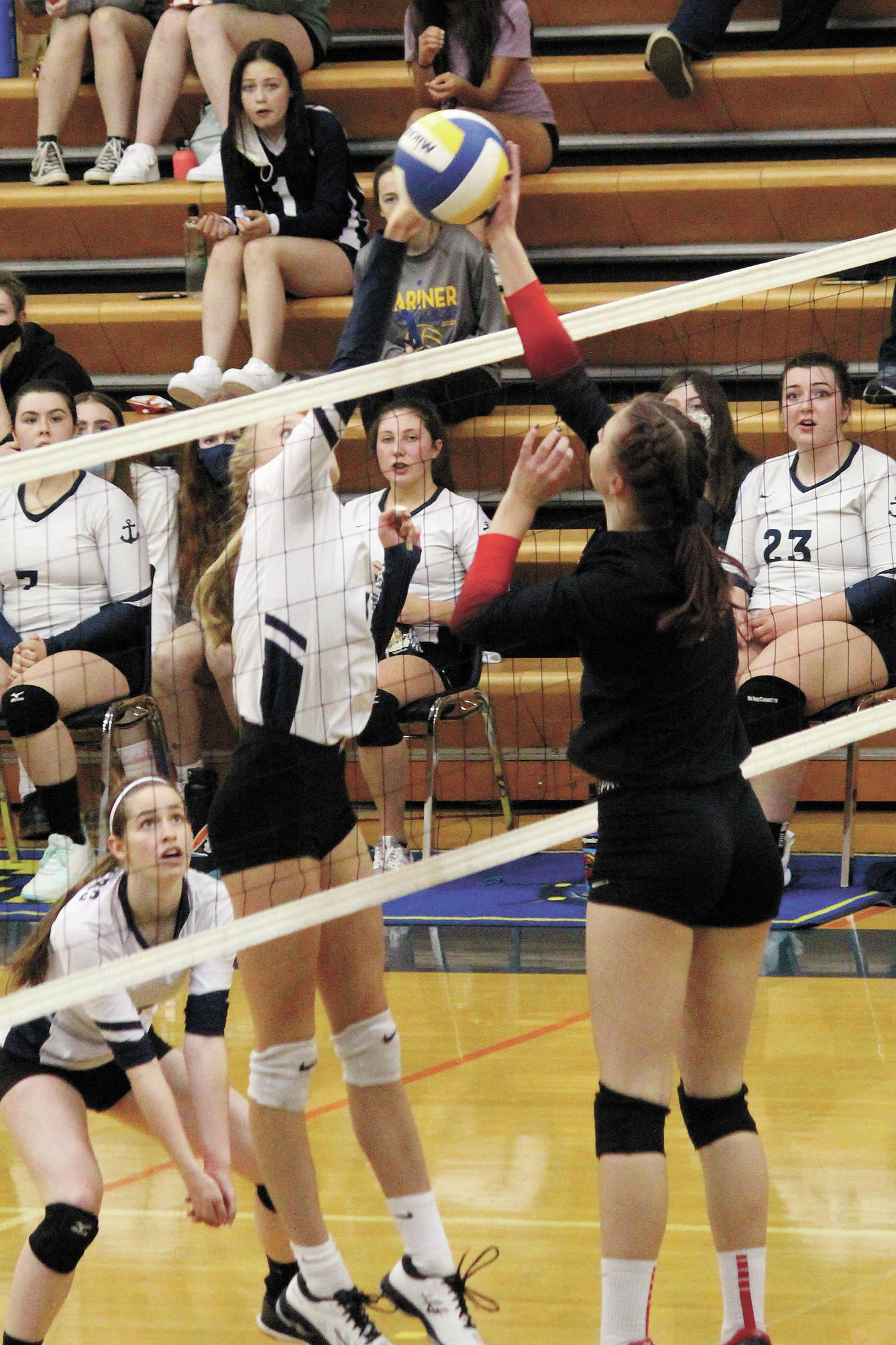 Homer’s Gracie Gummer and Kenai’s Erin Koziczkowski meet across the net during a Tuesday, Oct. 6, 2020 volleyball game in the Alice Witte Gymnasium in Homer, Alaska. (Photo by Megan Pacer/Homer News)