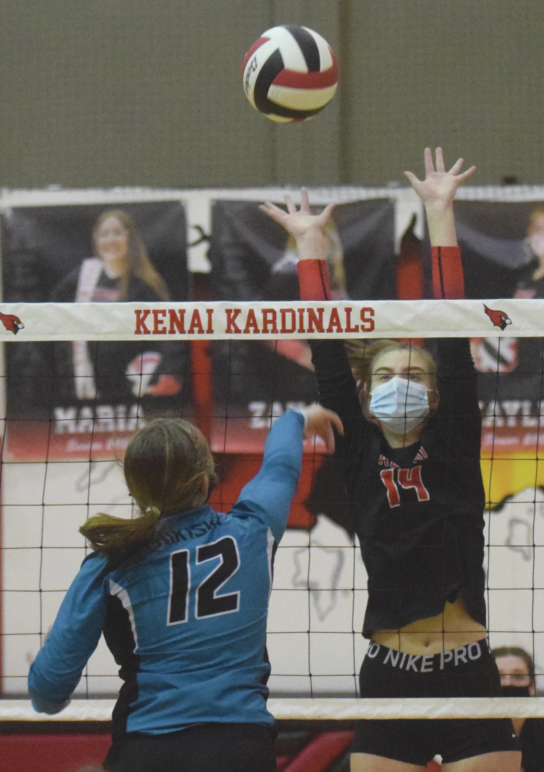 Kenai Central’s Erin Koziczkowski puts up a block on Nikiski’s Camry Ellis on Thursday, Nov. 5, 2020, at Kenai Central High School in Kenai, Alaska. (Photo by Jeff Helminiak/Peninsula Clarion)