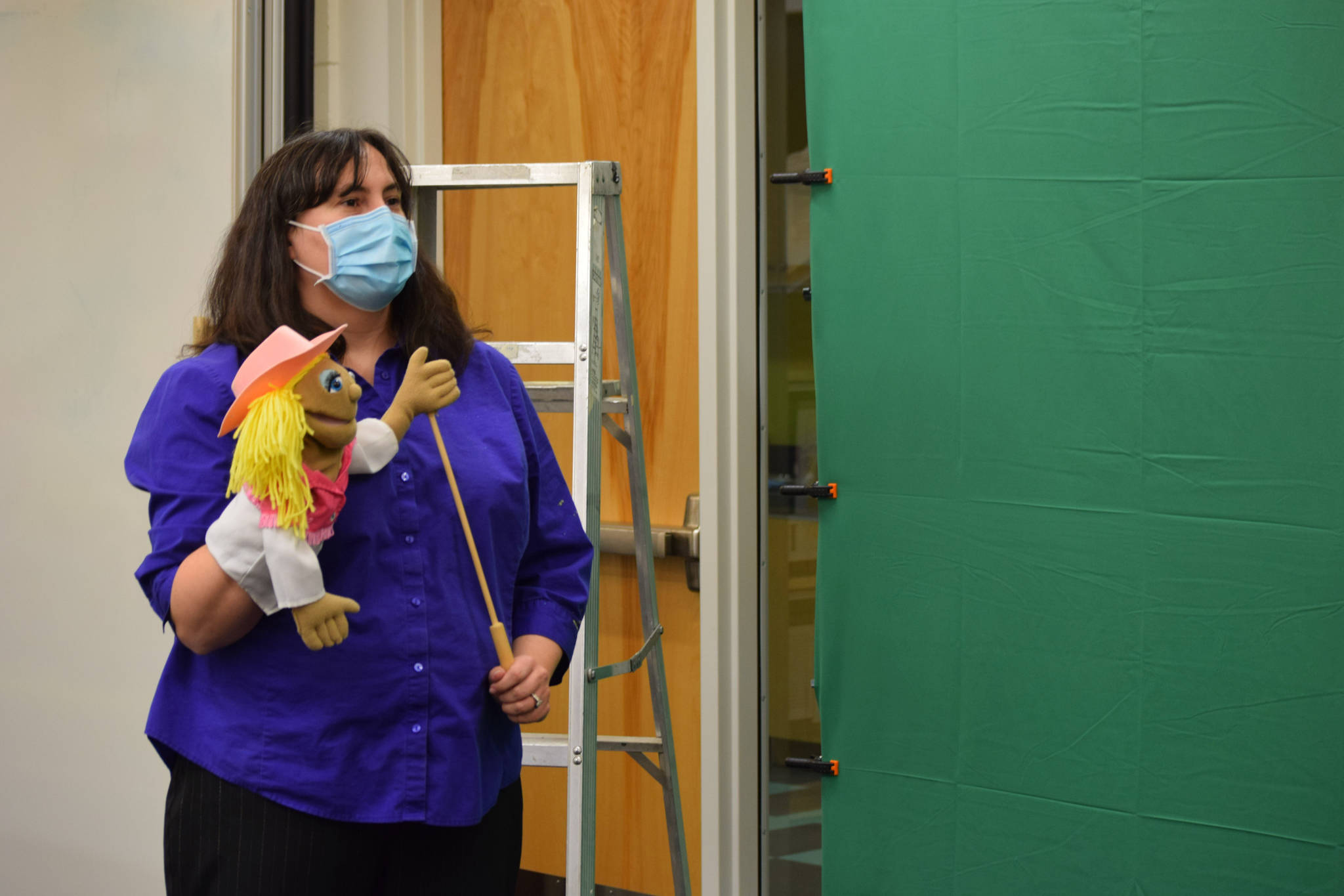 Kenai Community Library Program Coordinator Elizabeth Kleweno holds a puppet at Kenai Community Library on Friday, Dec. 11 in Kenai, Alaska.