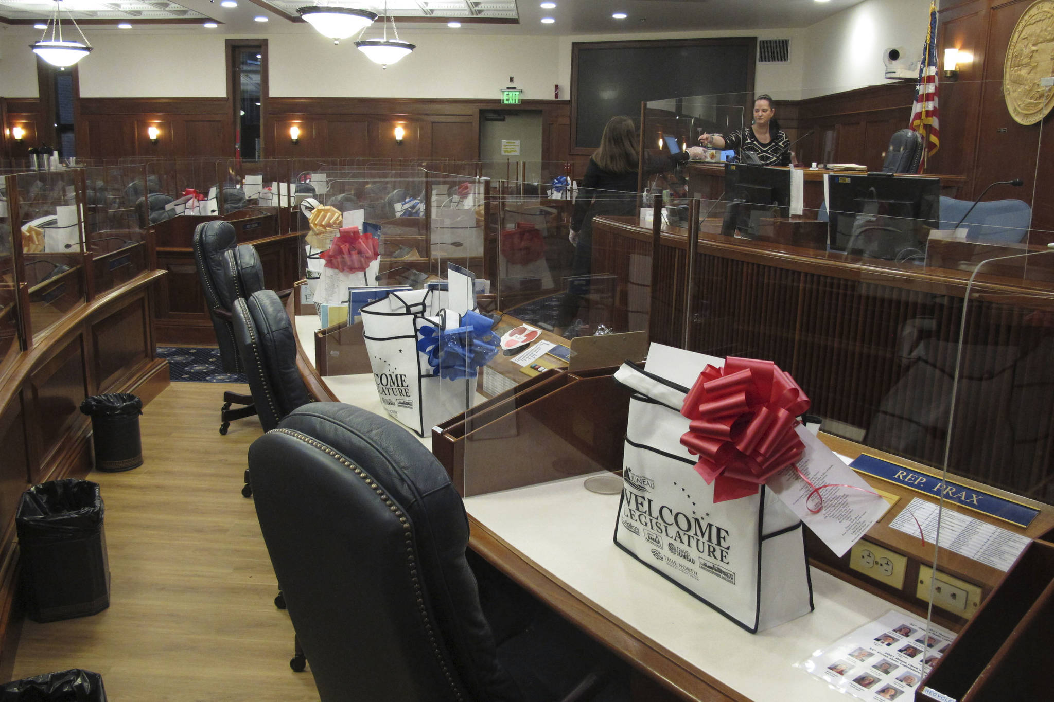 AP Photo / Becky Bohrer 
Welcome bags and plexiglass dividers placed around their desks await lawmakers on the Alaska House floor in Juneau. The committee was among several that had scheduled meetings Monday, the last day before the new Legislature is set to convene Tuesday.