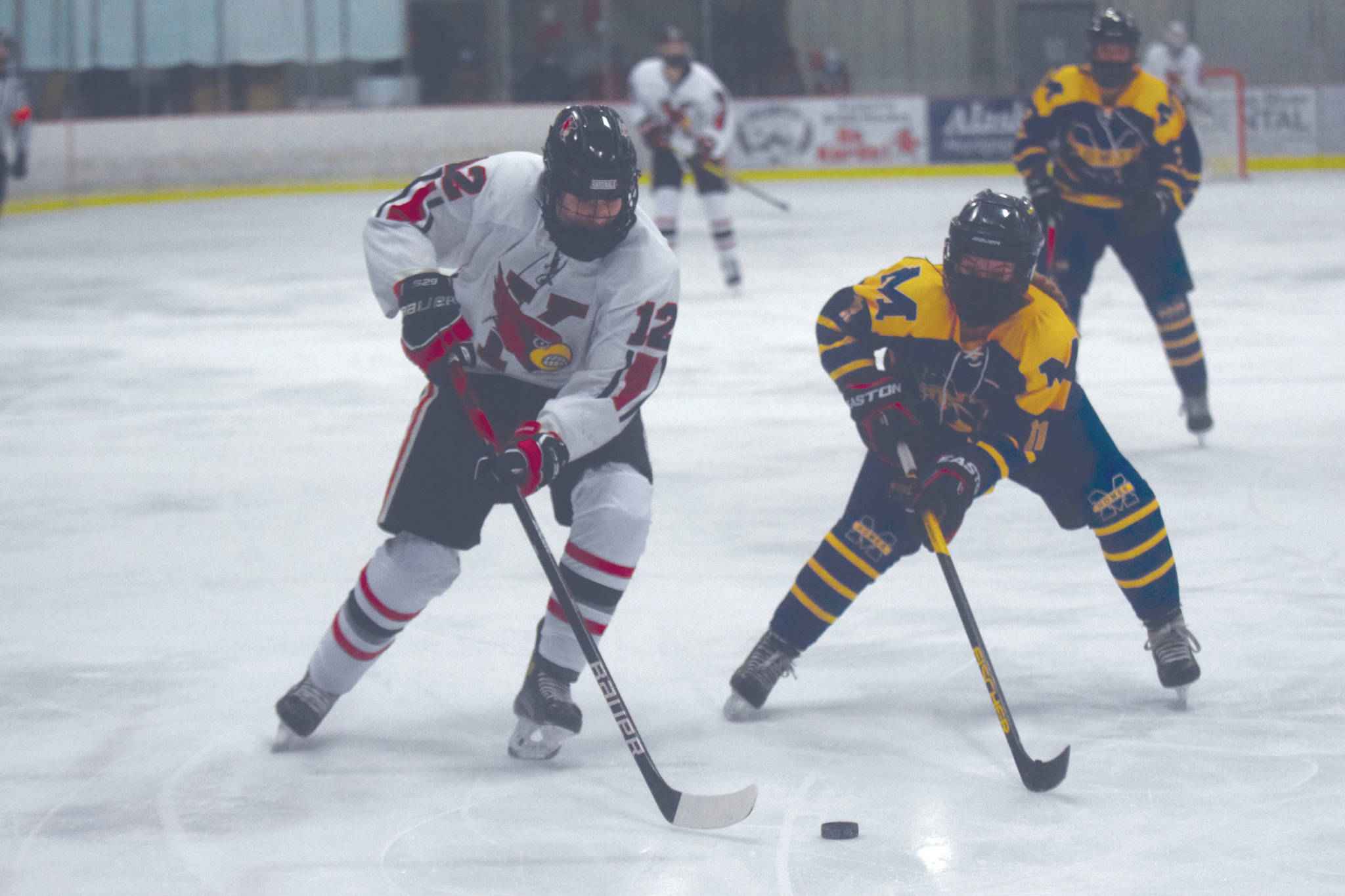 Kenai Central’s Landen Cialek attacks the net with Homer’s Fiona Hatton defending Tuesday, Feb. 2, 2021, at the Kenai Multi-Purpose Facility in Kenai, Alaska. (Photo by Jeff Helminiak/Peninsula Clarion)