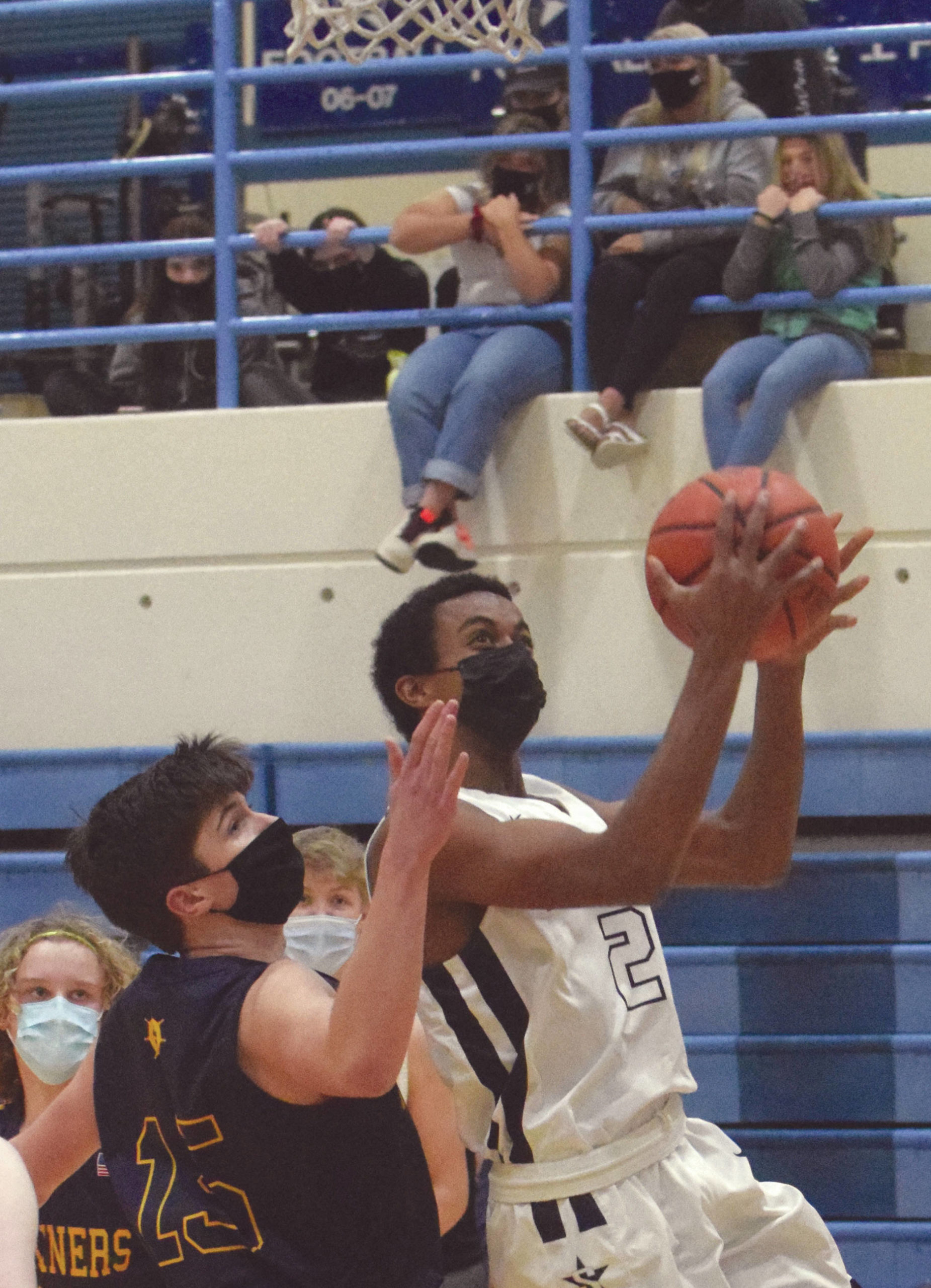 Soldotna’s Maleda Denbrock drives on Homer’s Ryan Carroll on Saturday, Feb. 6, 2021, at Soldotna High School in Soldotna, Alaska. (Photo by Jeff Helminiak)