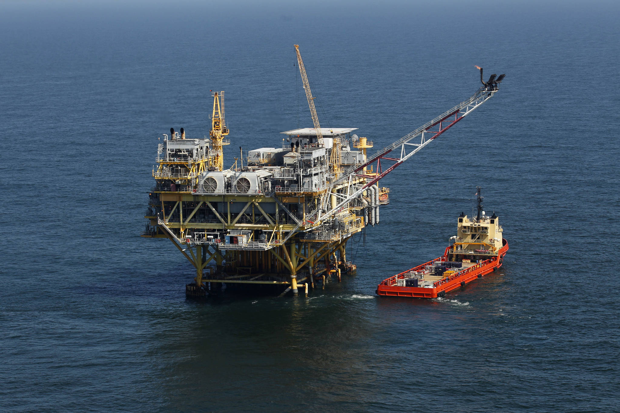 This Sunday, April 10, 2011 picture shows a rig and supply vessel in the Gulf of Mexico, off the cost of Louisiana. Thirteen states sued the Biden administration Wednesday, March 24, 2021 to end a suspension of new oil and gas leases on federal land and water and to reschedule canceled sales of offshore leases in the Gulf of Mexico, Alaska waters and western states. The Republican-leaning states, led by Louisiana Attorney General Jeff Landry, seek a court order ending the moratorium imposed after Democratic President Joe Biden signed executive orders on climate change on Jan. 27. (AP Photo/Gerald Herbert)