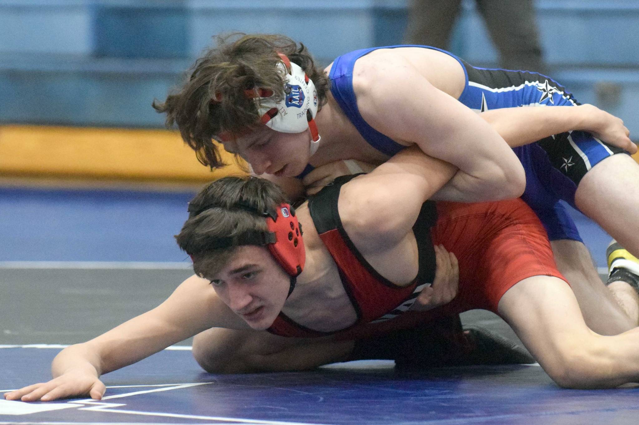 Soldotna's Ezekiel Miller controls Kenai Central's Owen Whicker at 130 pounds Friday, April 9, 2021, at Soldotna High School in Soldotna, Alaska. Miller won by major decision, 11-1. (Photo by Jeff Helminiak/Peninsula Clarion)