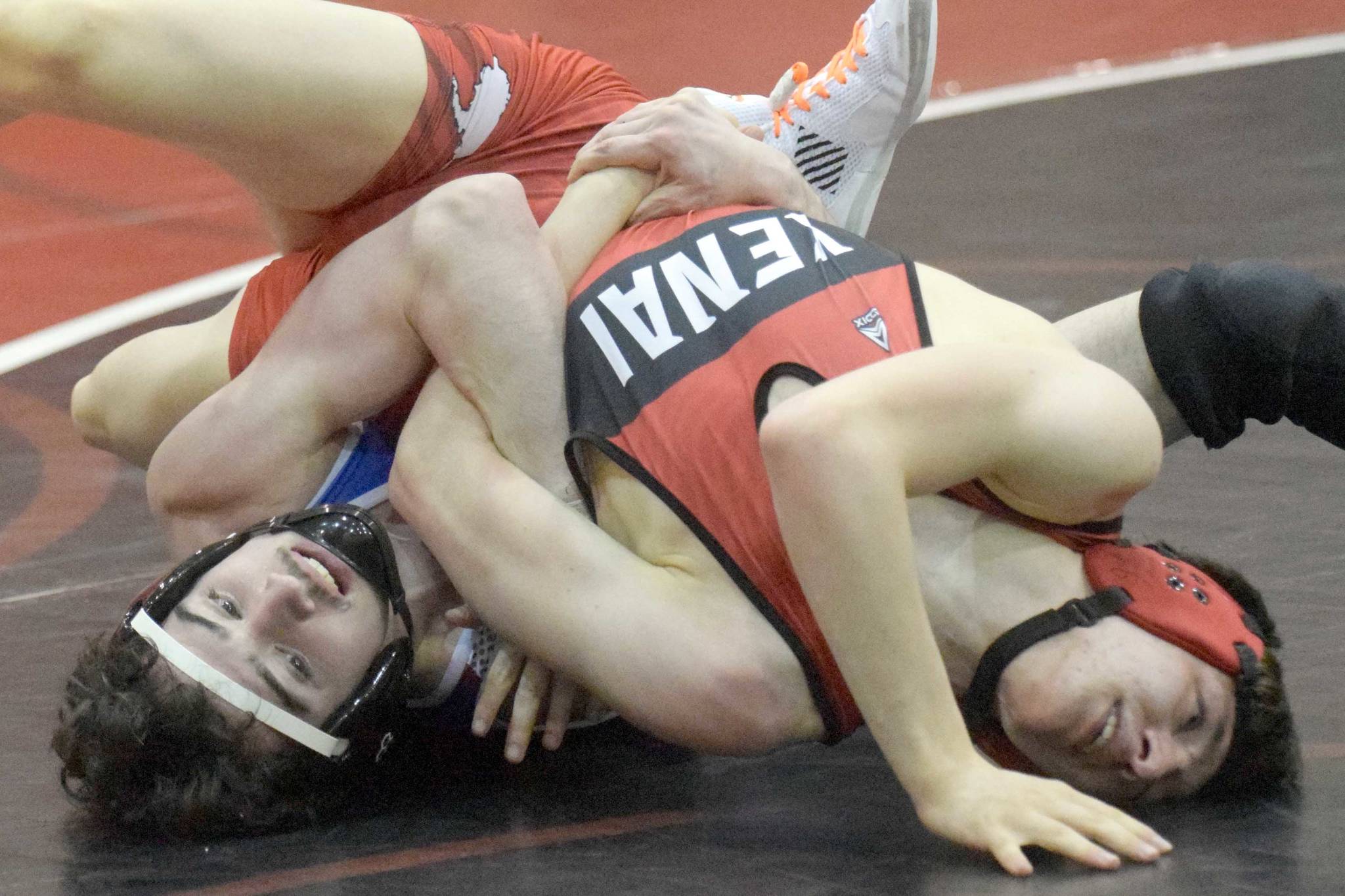 Caleb O'Hara works to a major decision of Kenai Central's Talon Whicker at 125 pounds Tuesday, April 13, 2021, at Kenai Central High School in Kenai, Alaska. (Photo by Jeff Helminiak/Peninsula Clarion)