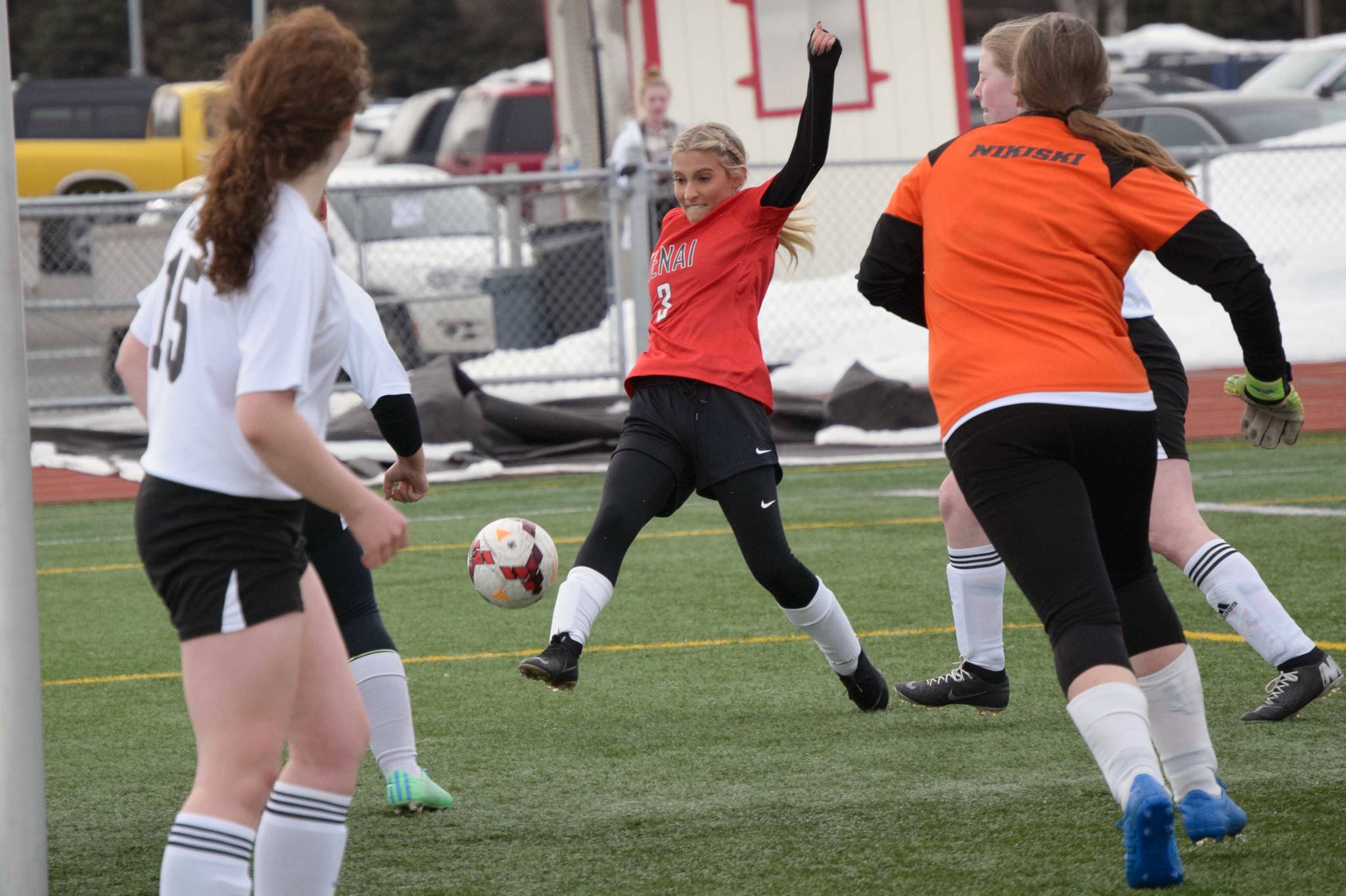 Kenai Central's Karley Harden attacks the Nikiski net Thursday, April 15, 2021, at Kenai Central High School in Kenai, Alaska. (Photo by Jeff Helminiak/Peninsula Clarion)