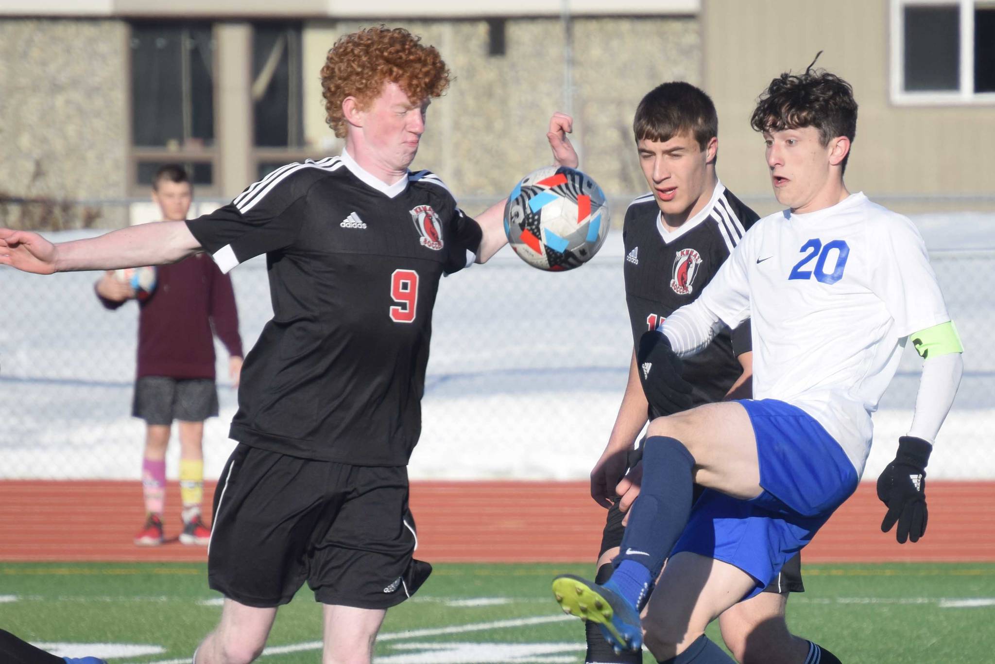 Kenai Central's Joe Hamilton and Tucker Vann take on Soldotna's Josh Heiber on Tuesday, April 20, 2021, at Kenai Central High School in Kenai, Alaska. (Photo by Jeff Helminiak/Peninsula Clarion)