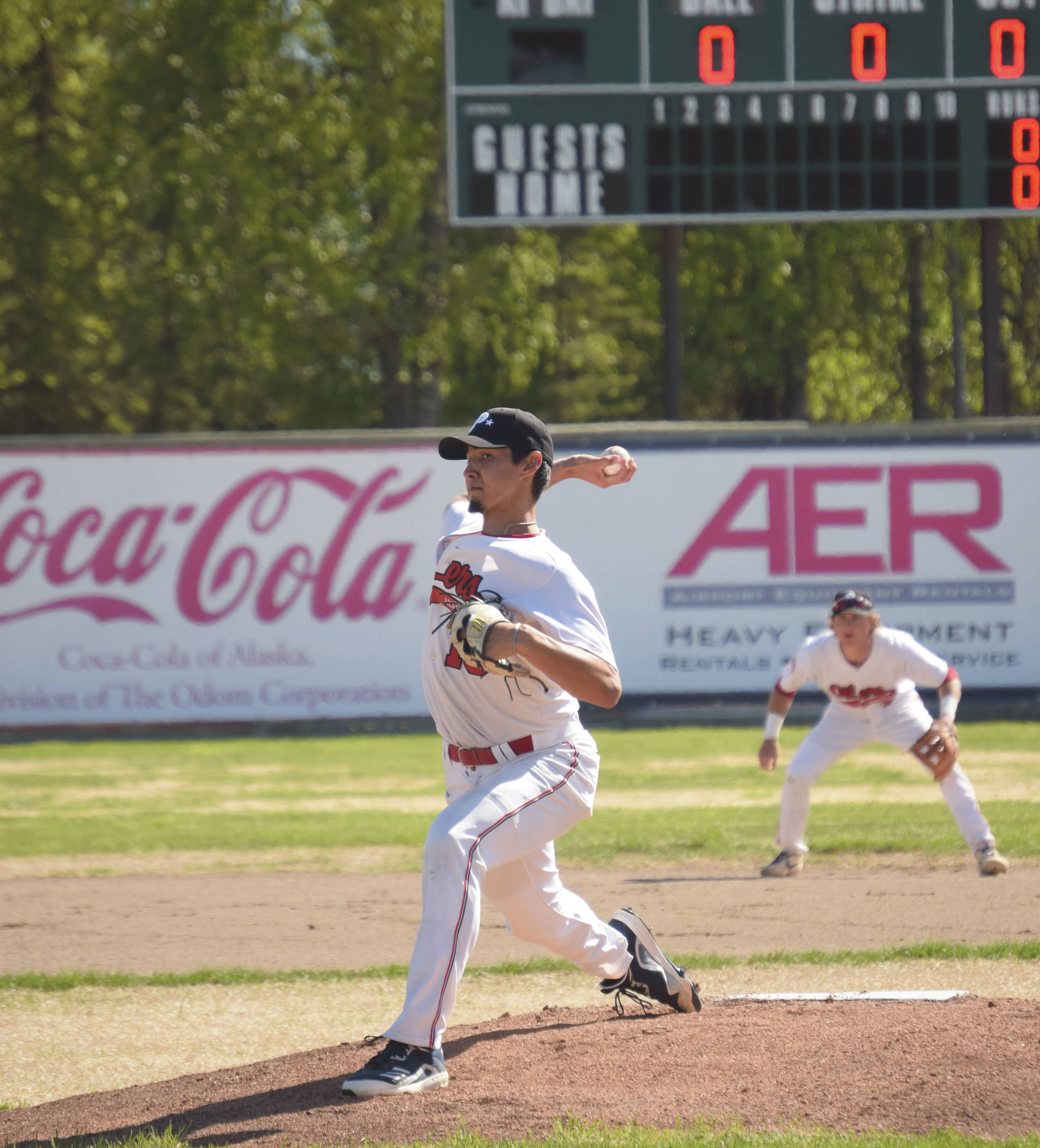 Oilers starting pitcher Liam Rocha delivers the first pitch of the season to the Alaska Goldpanners of Fairbanks on Saturday, June 5, 2021, at Coral Seymour Memorial Park in Kenai, Alaska. (Photo by Jeff Helminiak/Peninsula Clarion)