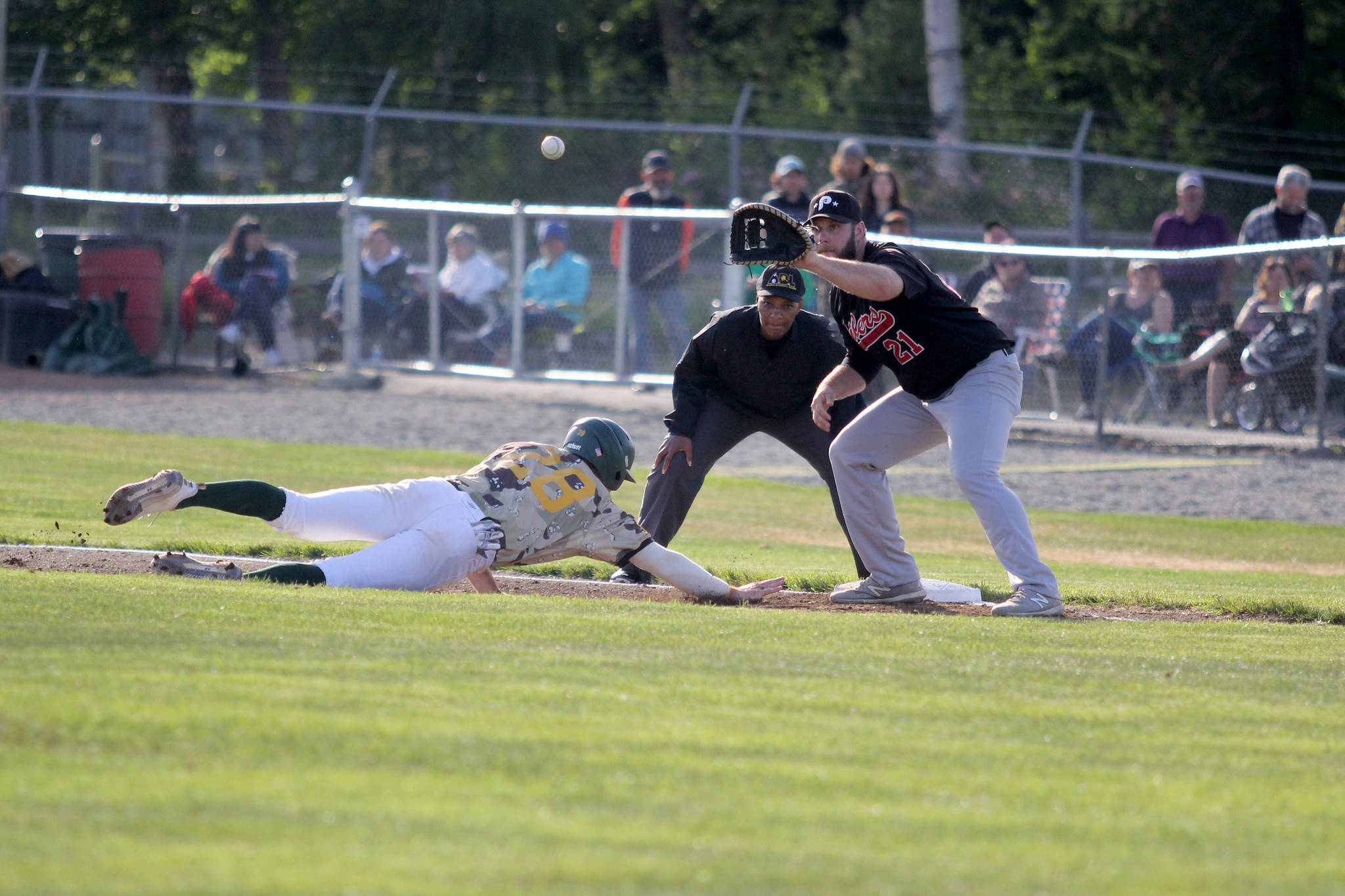 Mat-Su Miners infielder Gerard Sweeney slides back into first during a 2-1 win over the Peninsula Oilers Thursday, June 10, 2021, at Hermon Brothers Field in Palmer. (Jeremiah Bartz/Frontiersman)