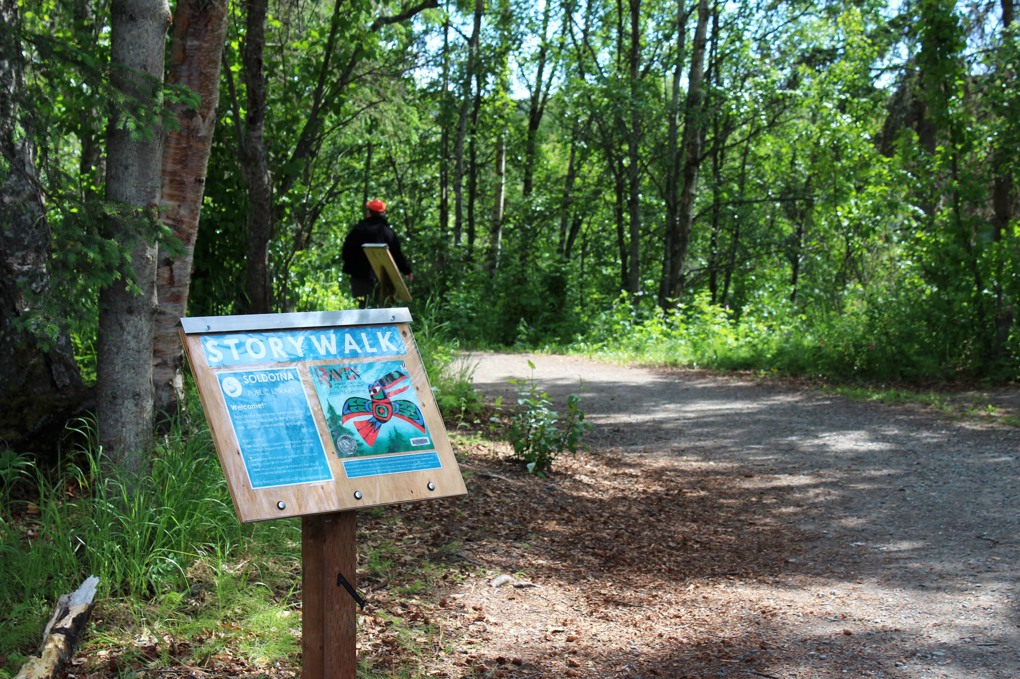 A podium marks the beginning of a StoryWalk at Soldotna Creek Park on Tuesday, June 29, 2021 in Soldotna, Alaska. (Ashlyn O’Hara/Peninsula Clarion)