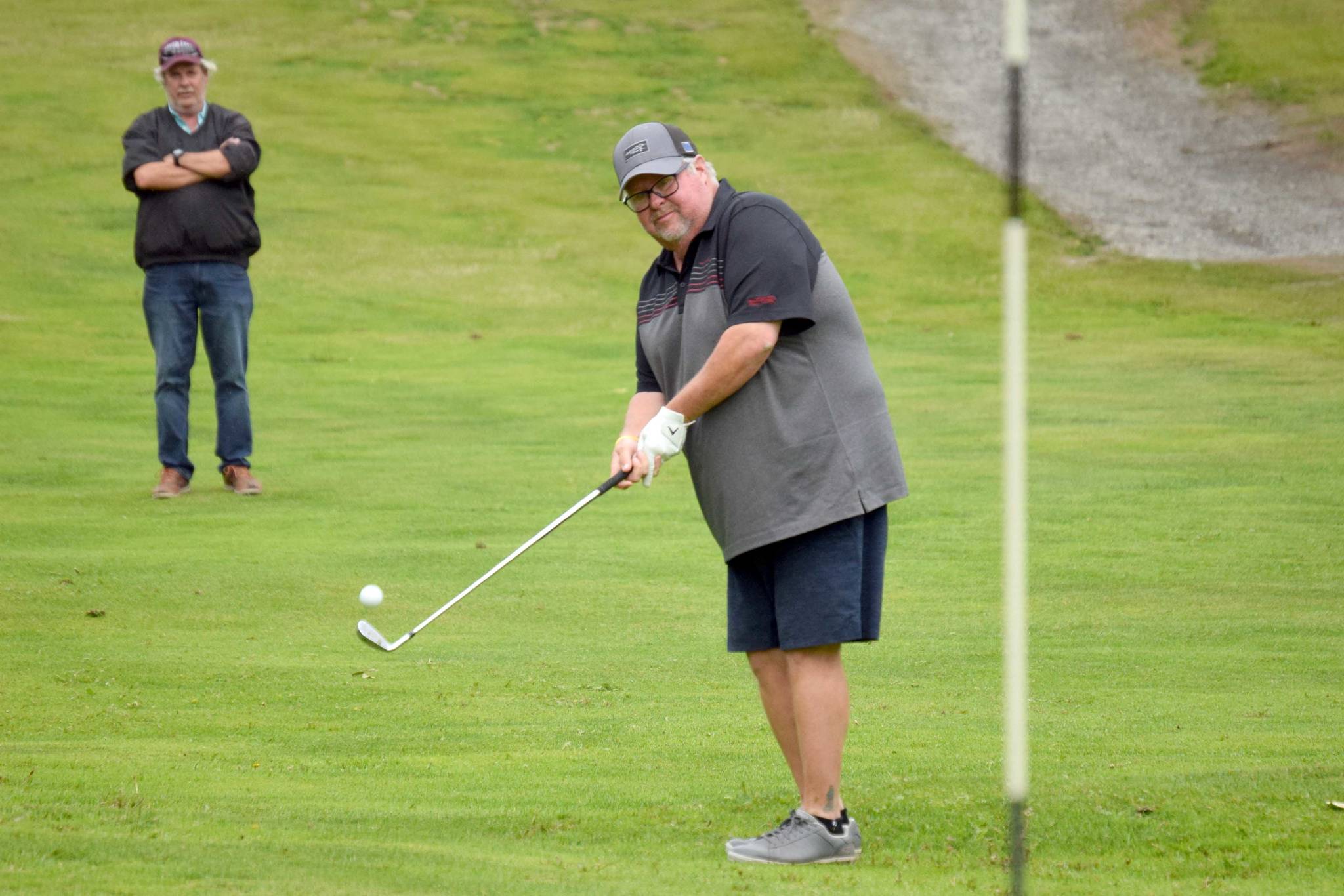 Palmer pro George Collum chips to the fourth green Monday, July 12, 2021, during the State Farm Pro and Skins Game at Birch Ridge Golf Course in Soldotna, Alaska. (Photo by Jeff Helminiak/Peninsula Clarion)