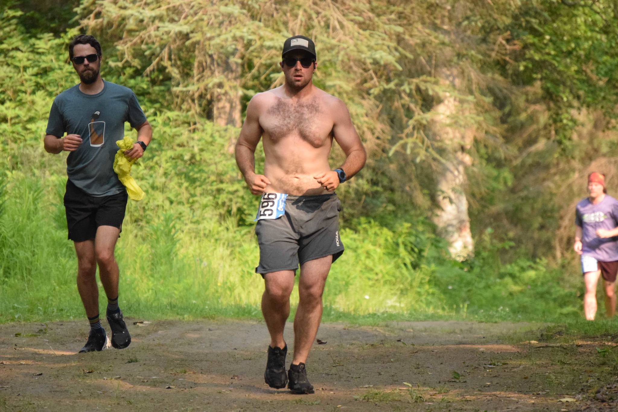 Elias Wheeler, of Soldotna, leads fellow 10K runners at the Rotary Unity Run at Tsalteshi Trails just outside of Soldotna, Alaska, on Saturday, July 17, 2021. (Photo by Jeff Helminiak/Peninsula Clarion)