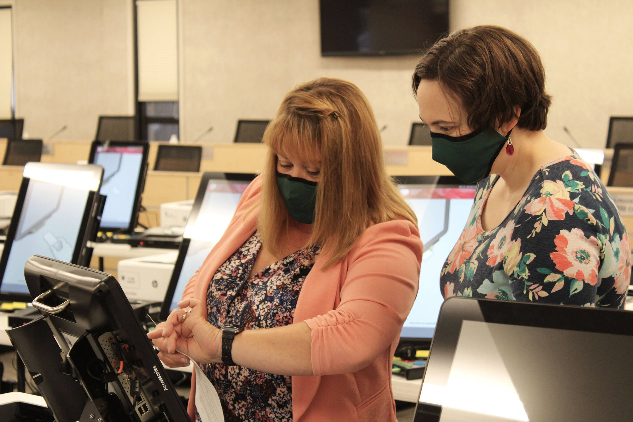 Shellie Saner (left) and Rachel Nash (right) test voting equipment ahead of the Oct. 5 municipal election on Thursday, Sept. 9, 2021 in Soldotna, Alaska. (Ashlyn O’Hara/Peninsula Clarion)