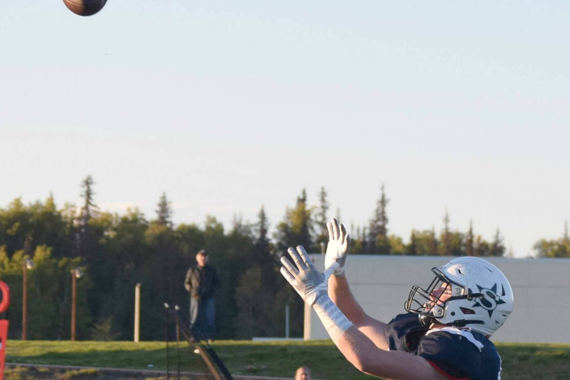 Dylan Dahlgren receives a long pass to score a touchdown during Soldotna High's homecoming footall game at Justin Maile Field in Soldotna, Alaska, on Friday, Sept. 10, 2021. (Camille Botello/Peninsula Clarion)