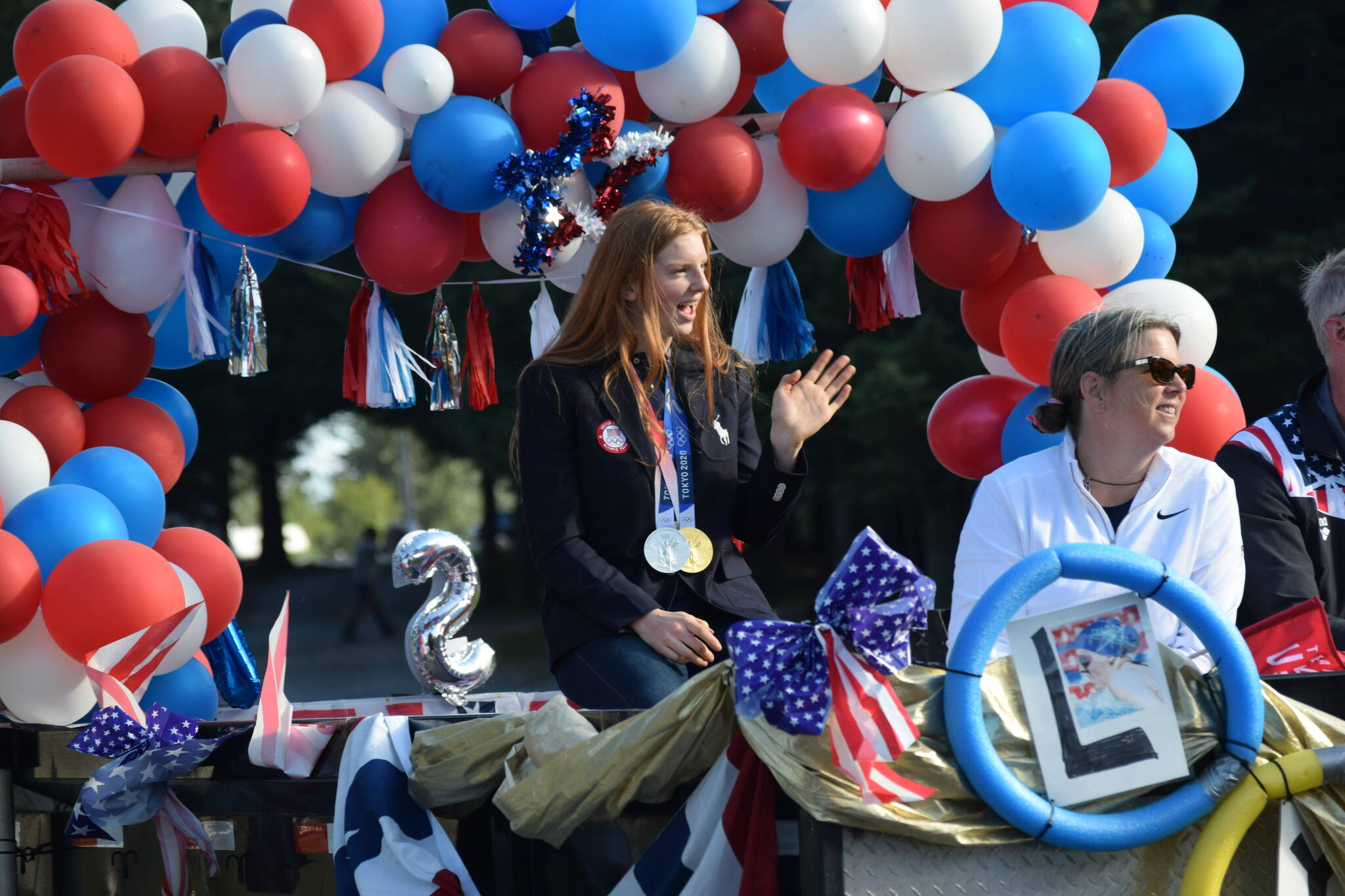 Olympic gold medalist Lydia Jacoby waves to the crowd in Seward during her celebratory parade on Thursday, August 5, 2021. (Camille Botello / Peninsula Clarion)