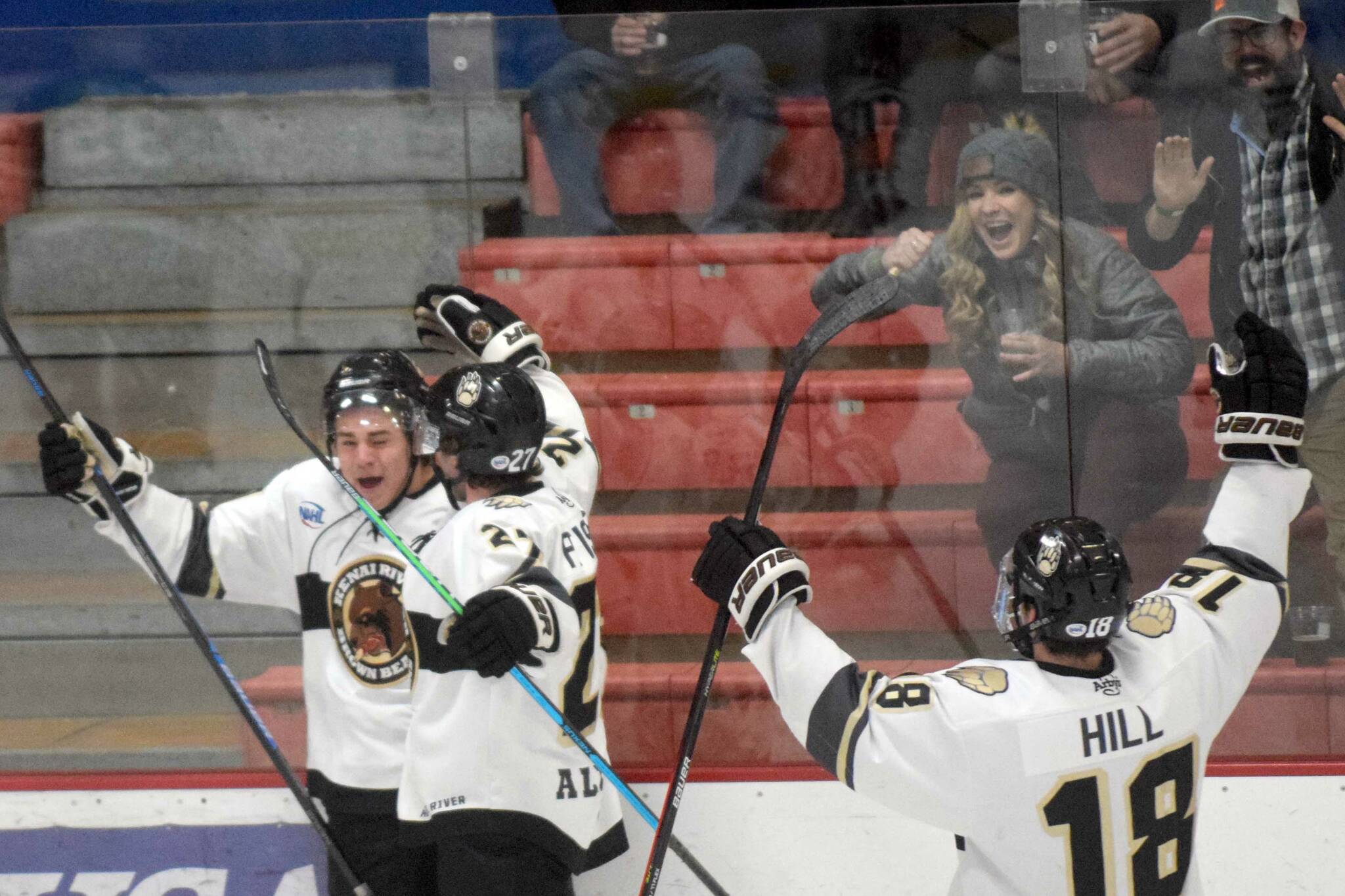 Kenai River Brown Bears forward Caden Triggs (far left) celebrates his first-period goal with Tyler Pfister and Brendan Hill on Friday, Oct. 21, 2021, at the Soldotna Regional Sports Complex in Soldotna, Alaska. (Photo by Jeff Helminiak/Peninsula Clarion)