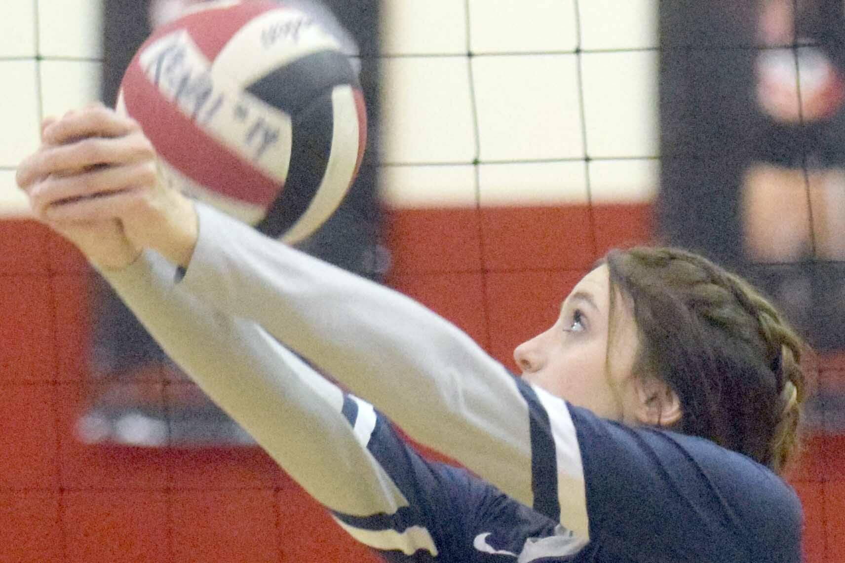 Soldotna's Adarra Hagelund bumps the ball over the net in front of Kenai Central's Erin Koziczkowski on Tuesday, Oct. 26, 2021, at Kenai Central High School in Kenai, Alaska. (Photo by Jeff Helminiak/Peninsula Clarion)