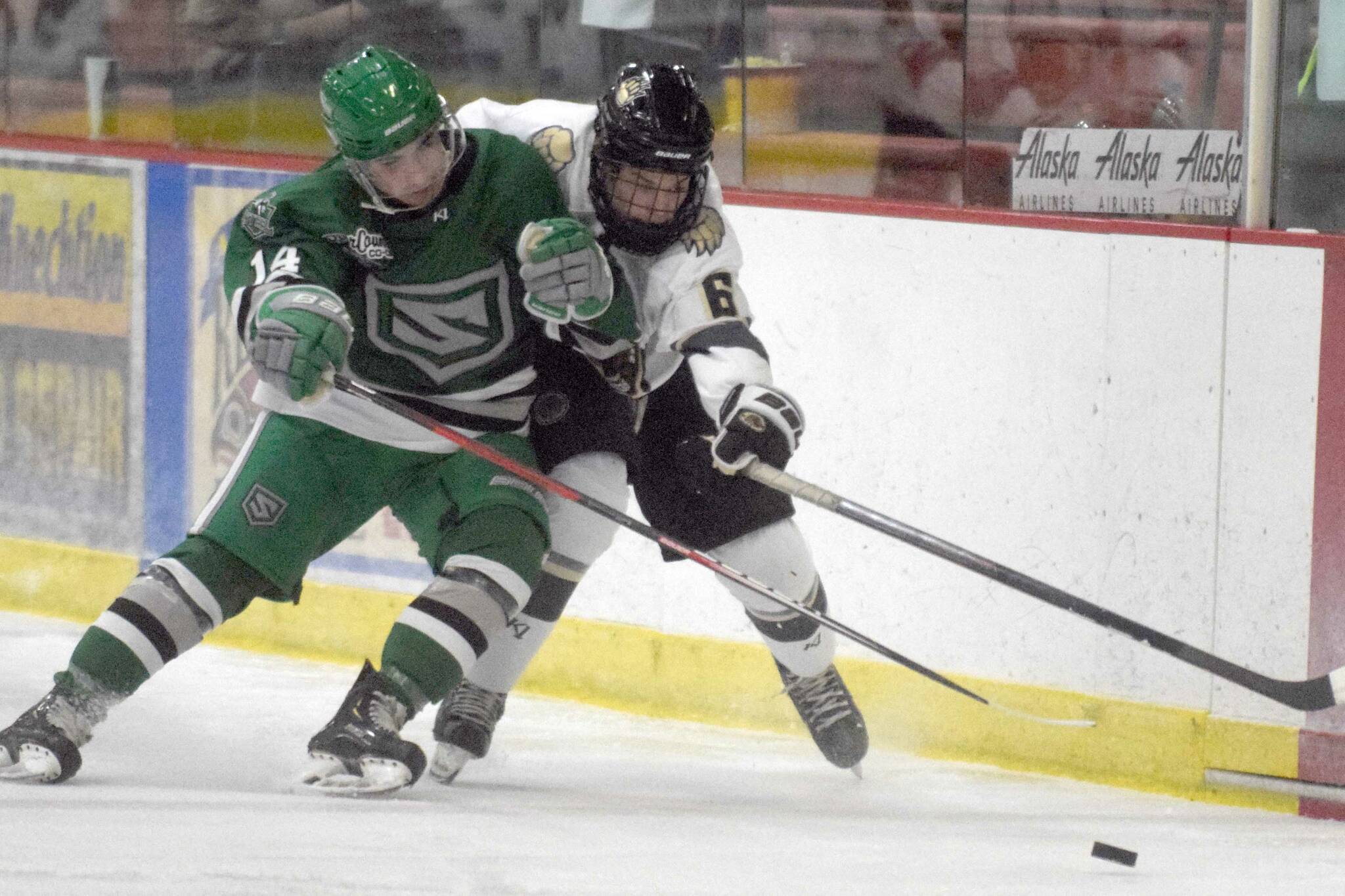 Jax Schauer of the Chippewa (Wisconsin) Steel and Dylan Evans of the Kenai River Brown Bears battle for the puck Friday, Oct. 21, 2021, at the Soldotna Regional Sports Complex in Soldotna, Alaska. (Photo by Jeff Helminiak/Peninsula Clarion)