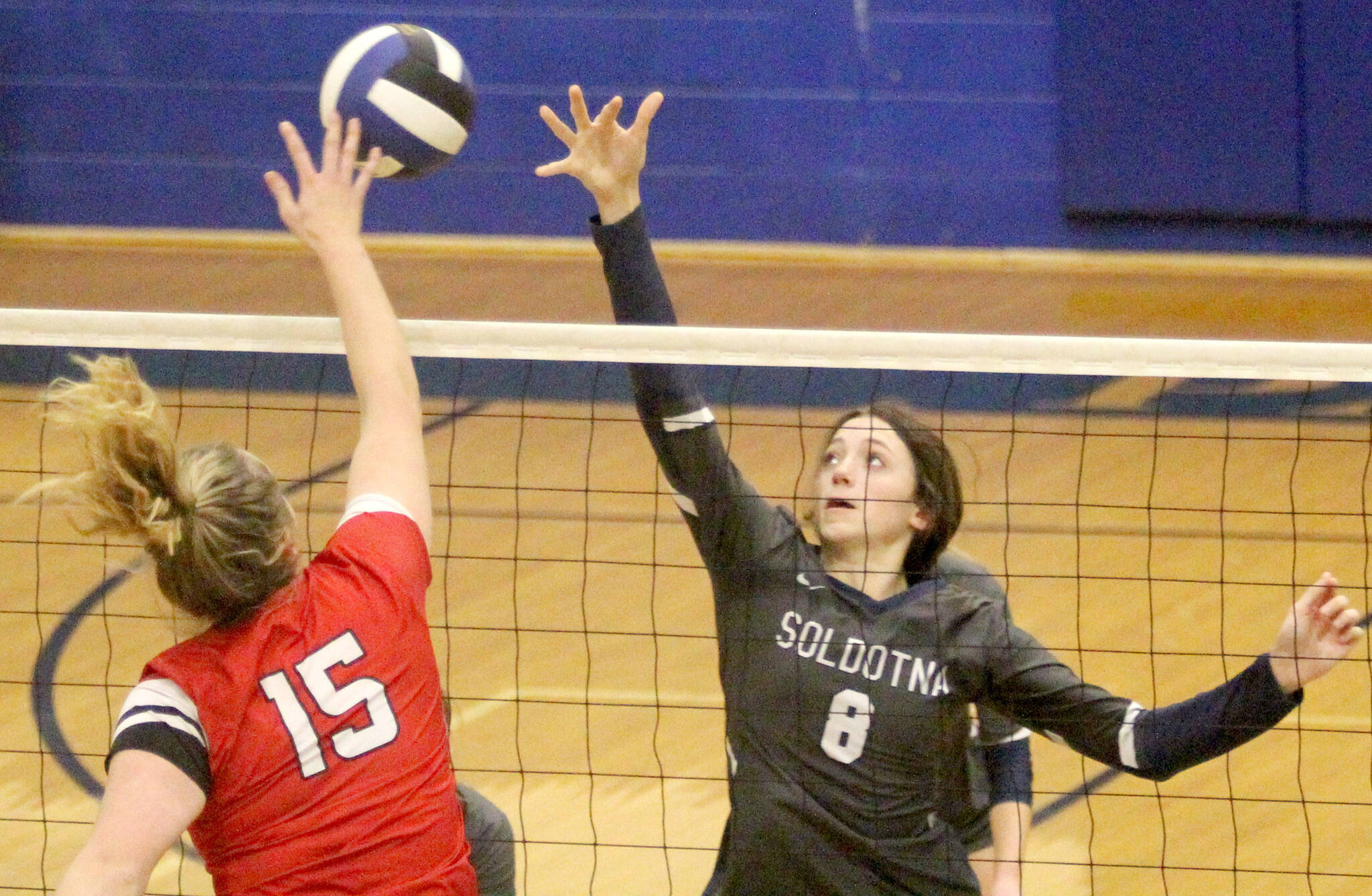 Soldotna’s Adarra Hagelund reaches to try to block a hit by Wasilla’s Bella Hays during a 3-0 win over the Warriors on the first day of the Northern Lights Conference tournament Friday, Nov. 4, 2021, at Palmer High School. (Jeremiah Bartz/Frontiersman)