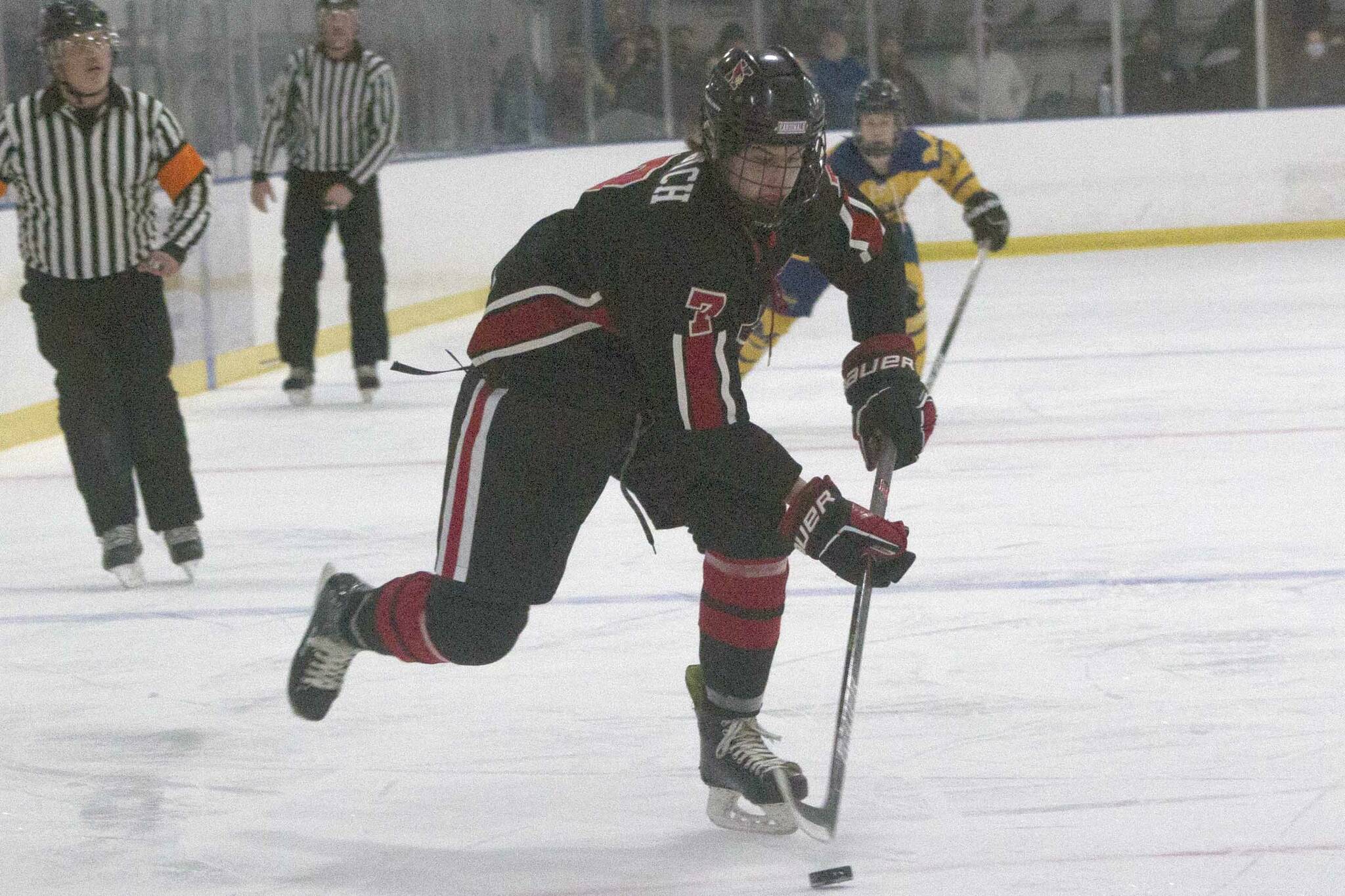 Kenai Central's Jacob Begich moves the puck against Homer on Friday, Nov. 6, 2021, at the Kevin Bell Arena in Homer, Alaska. (Photo by Sarah Knapp/Homer News)