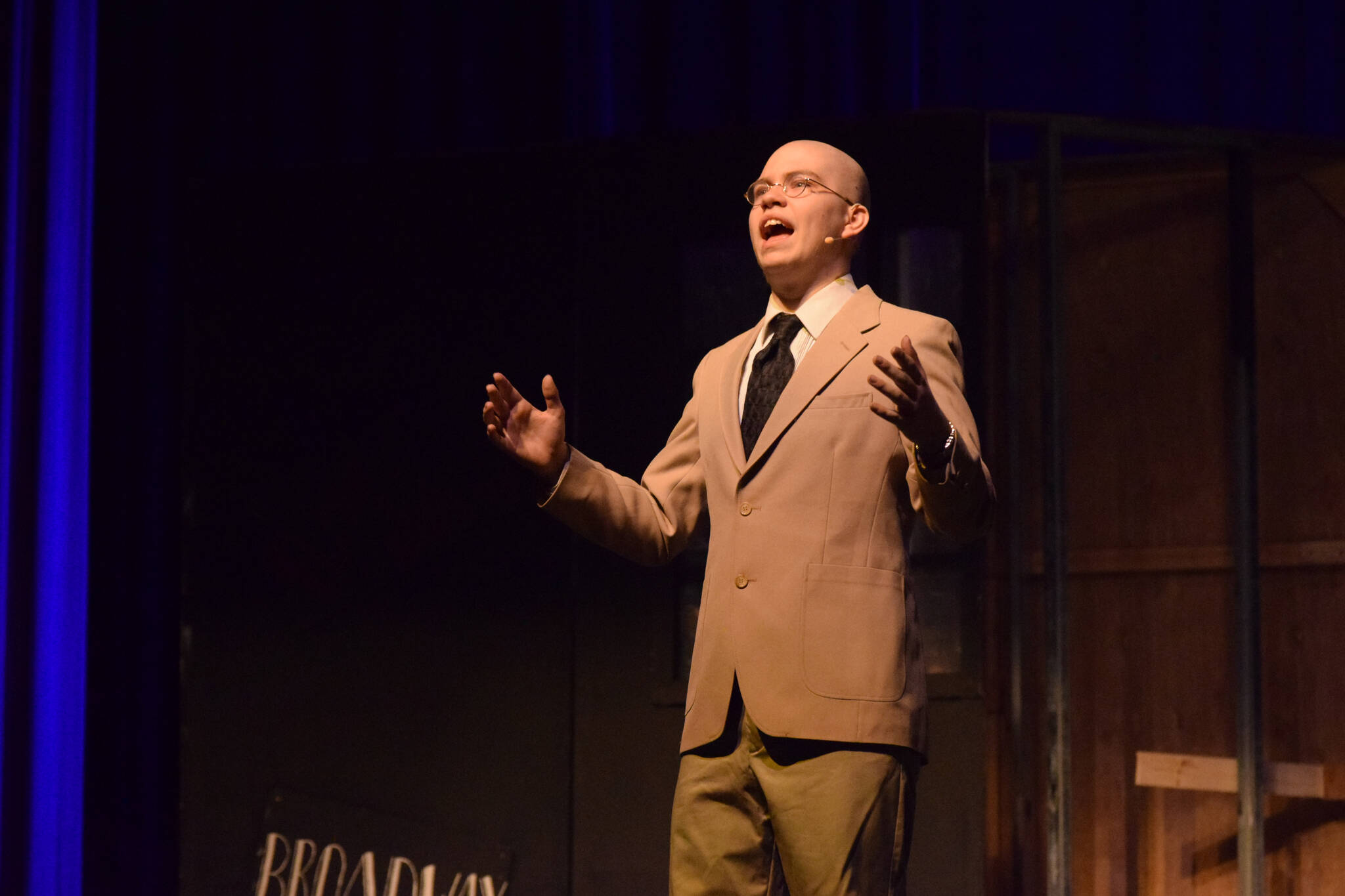 Josiah Burton performs as his character Oliver “Daddy” Warbucks in Soldotna High School’s production of “Annie” on Tuesday, Nov. 9, 2021. (Camille Botello/Peninsula Clarion)