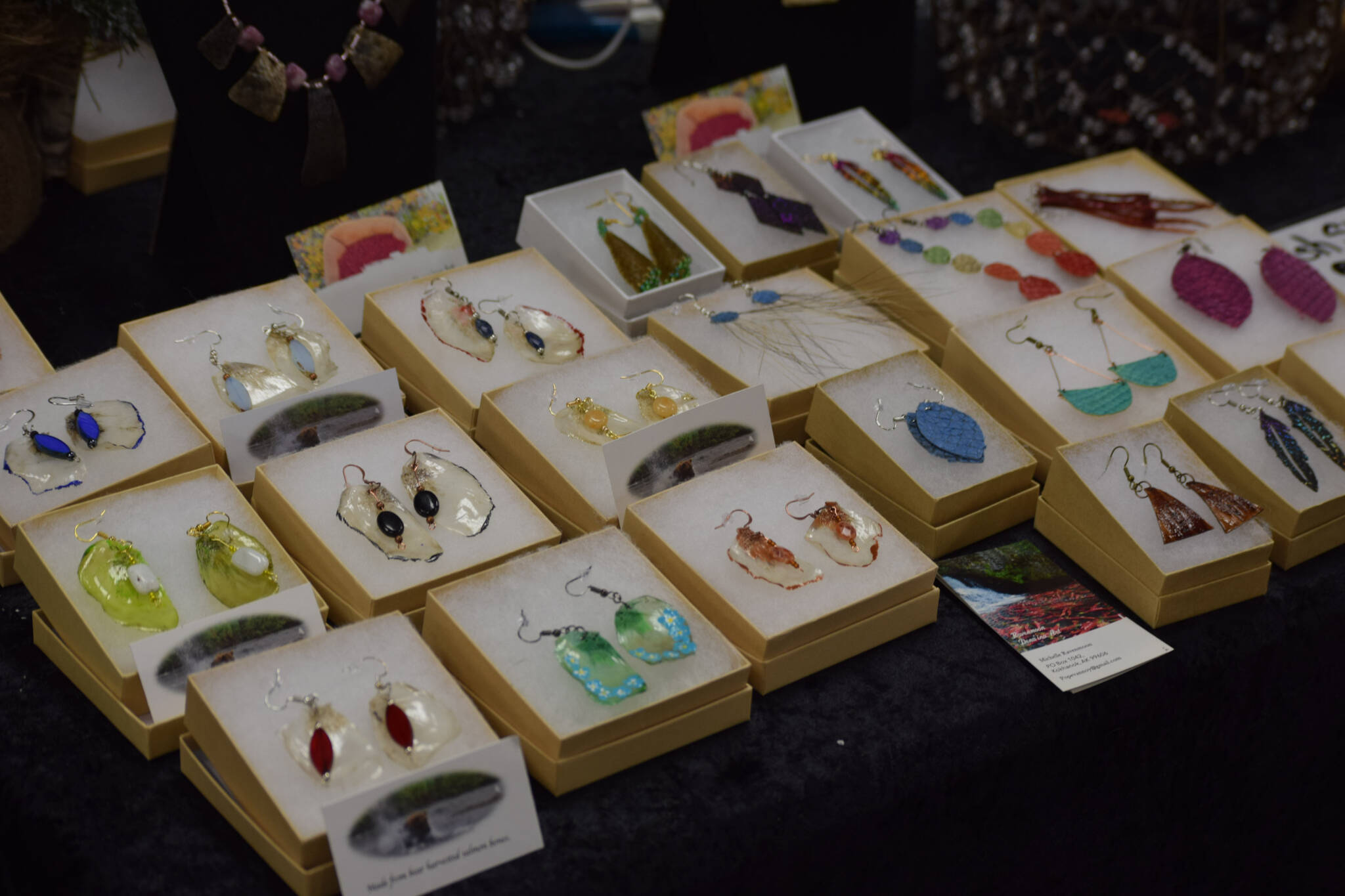 Michelle Ravenmoon sells salmon-bone earrings and other artisan products at the Soldotna Holiday Bazaar at the Soldotna Regional Sports Complex on Saturday, Nov. 20, 2021. (Camille Botello/Peninsula Clarion)