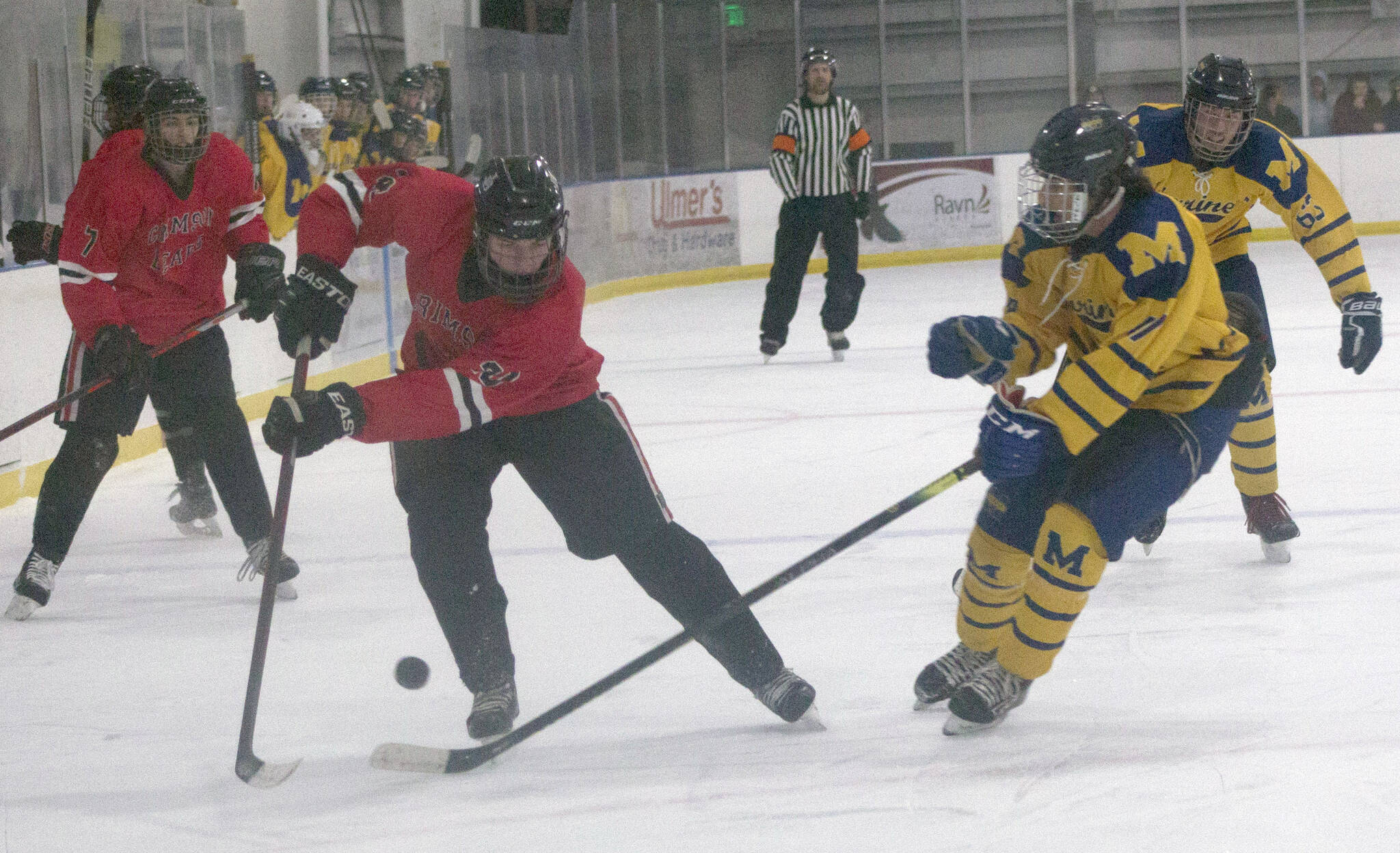 Brandonn Campbell of Juneau-Douglas keeps the puck from Dylan Arno of Homer on Friday, Dec. 3, 2021, at Kevin Bell Arena in Homer, Alaska. (Photo by Sarah Knapp/Homer News)