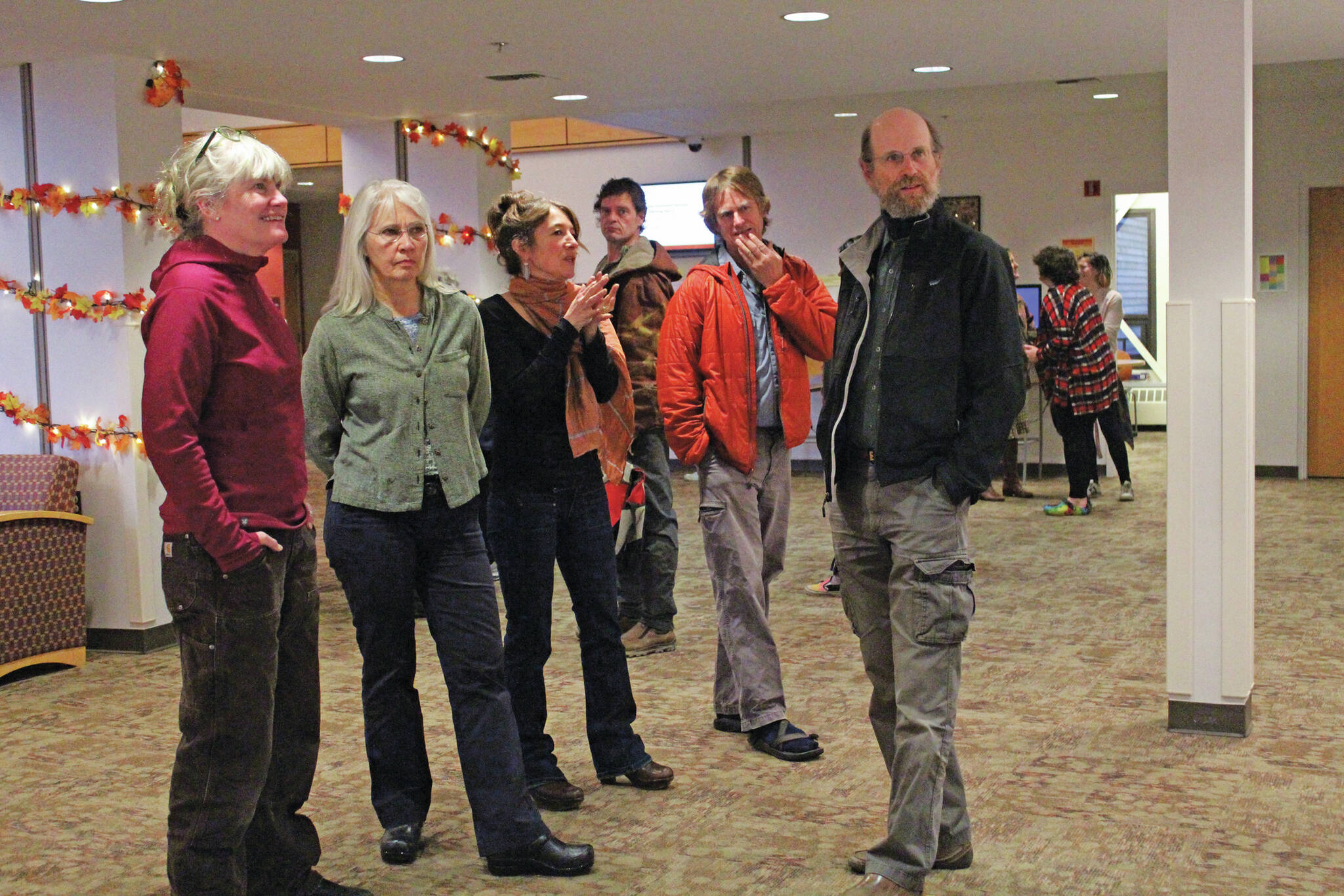 Megan Pacer / Homer News
Artist Asia Freeman, third from left, speaks to visitors on Nov. 1, 2019, at a First Friday art exhibit opening at Kachemak Bay Campus in Homer.