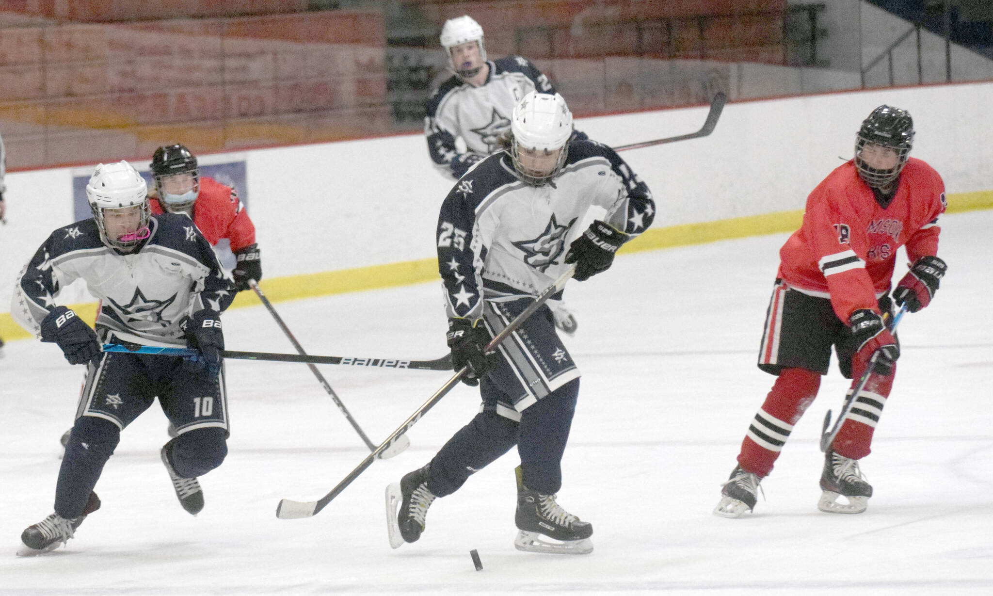 Soldotna’s Gehret Medcoff prepares to enter the zone with teammate Daniel Heath against Juneau-Douglas on Thursday, Jan. 6, 2022, at the Soldotna Regional Sports Complex in Soldotna, Alaska. (Photo by Jeff Helminiak/Peninsula Clarion)