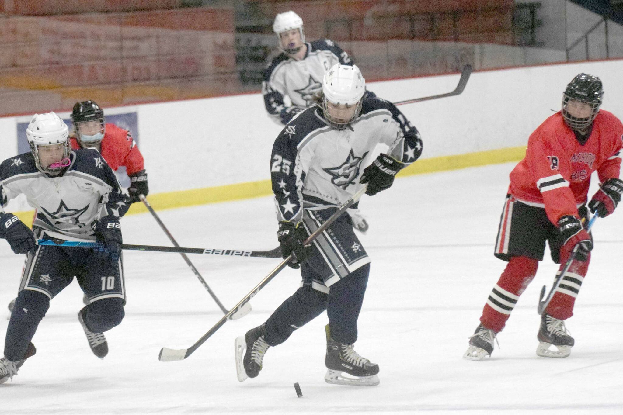 Soldotna's Gehret Medcoff prepares to enter the zone with teammate Daniel Heath against Juneau-Douglas on Thursday, Jan. 6, 2022, at the Soldotna Regional Sports Complex in Soldotna, Alaska. (Photo by Jeff Helminiak/Peninsula Clarion)